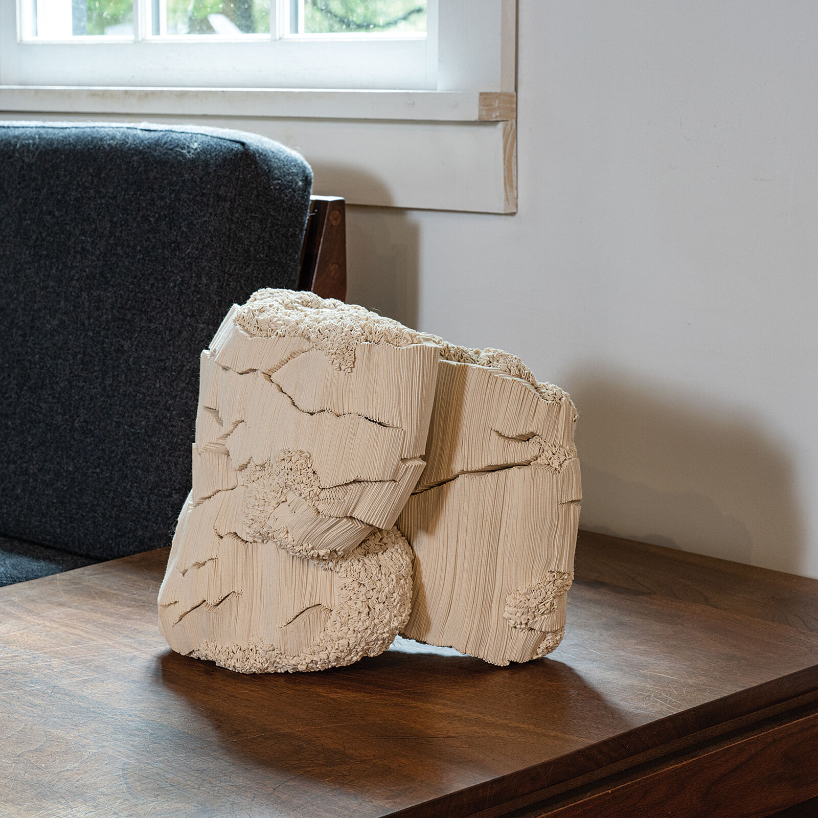 A wooden sculpture sitting on top of a wooden table.
