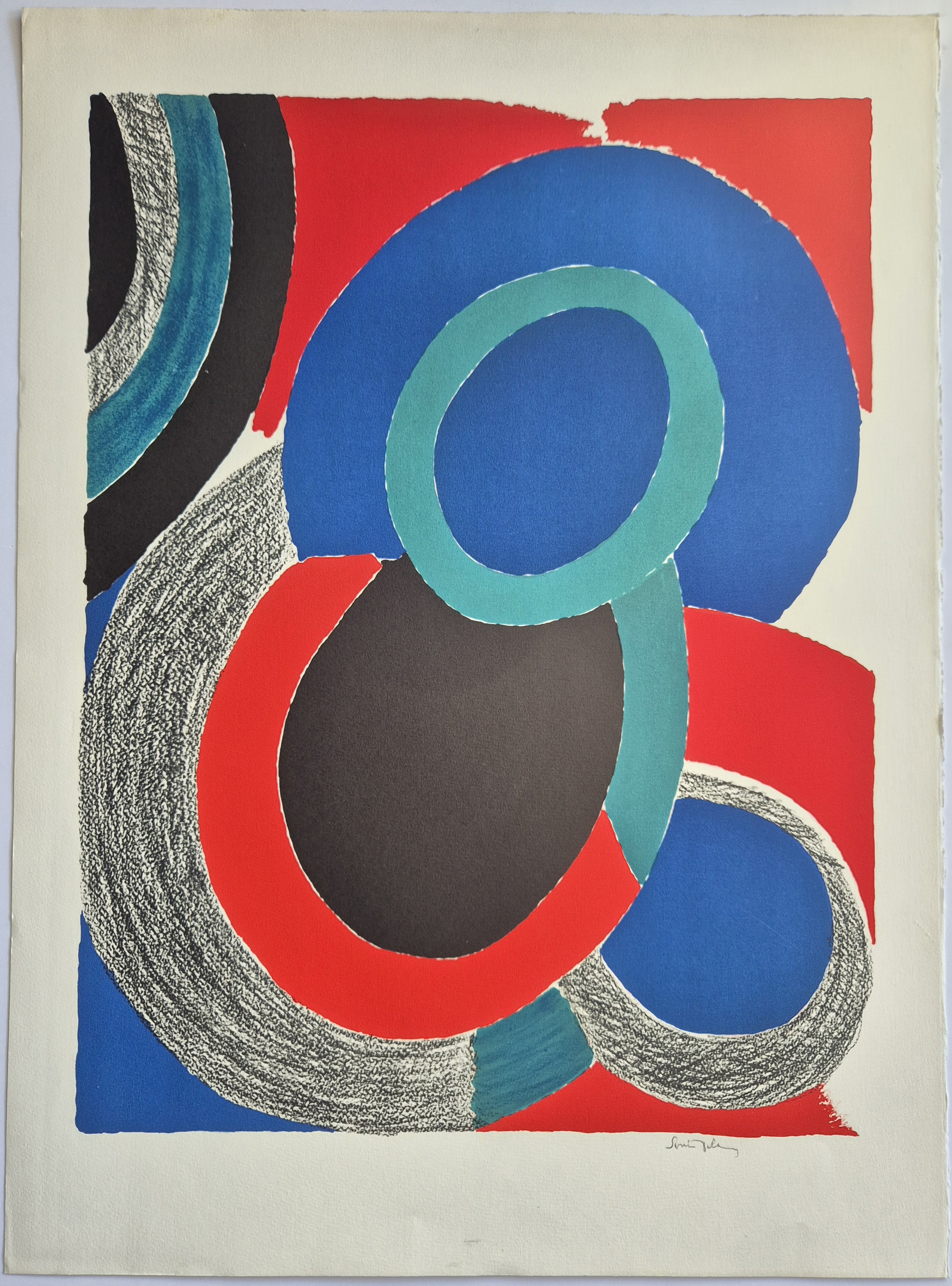 A blue, red, and black abstract painting on a white wall.