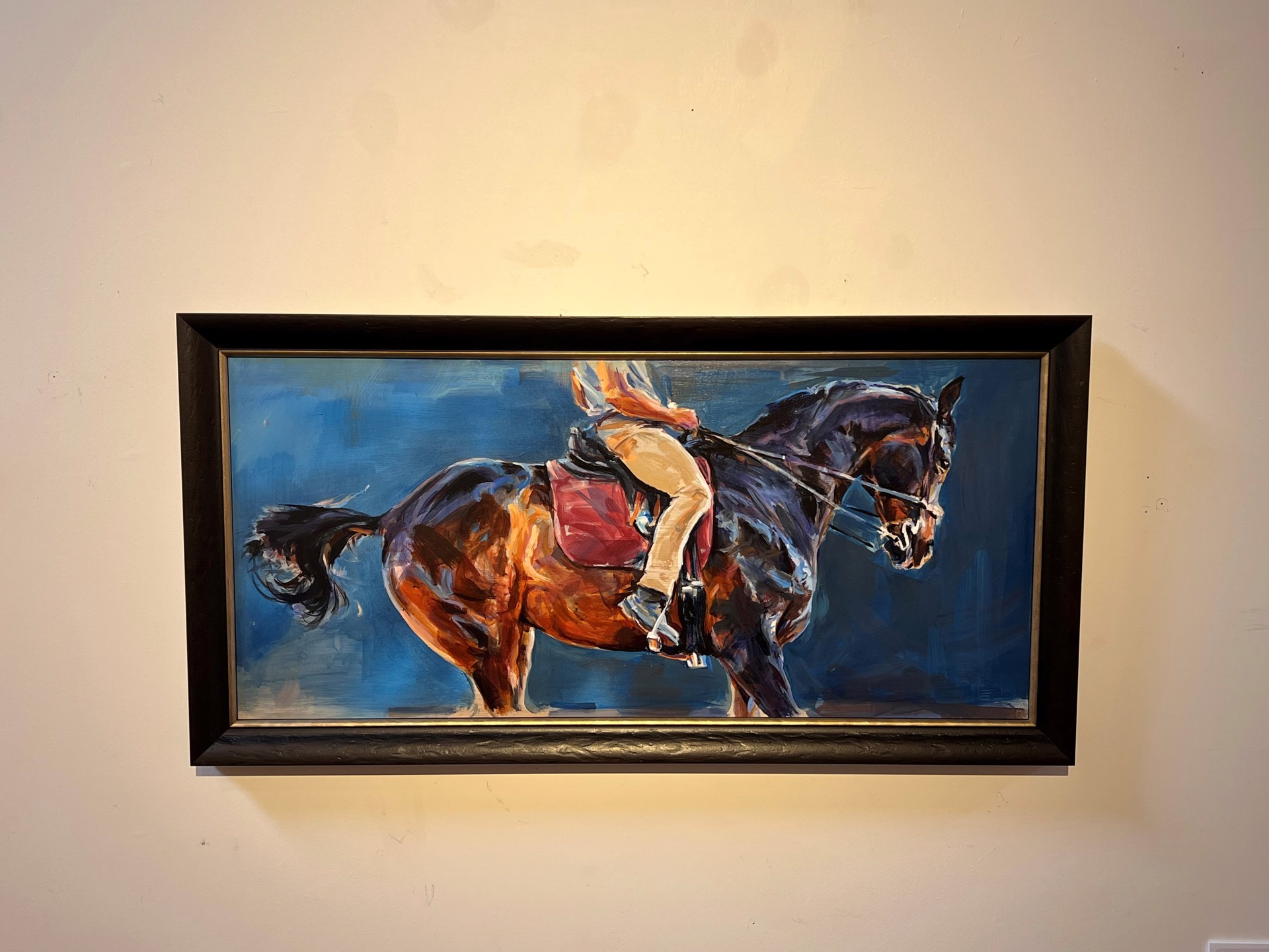 A painting of a person riding a horse.