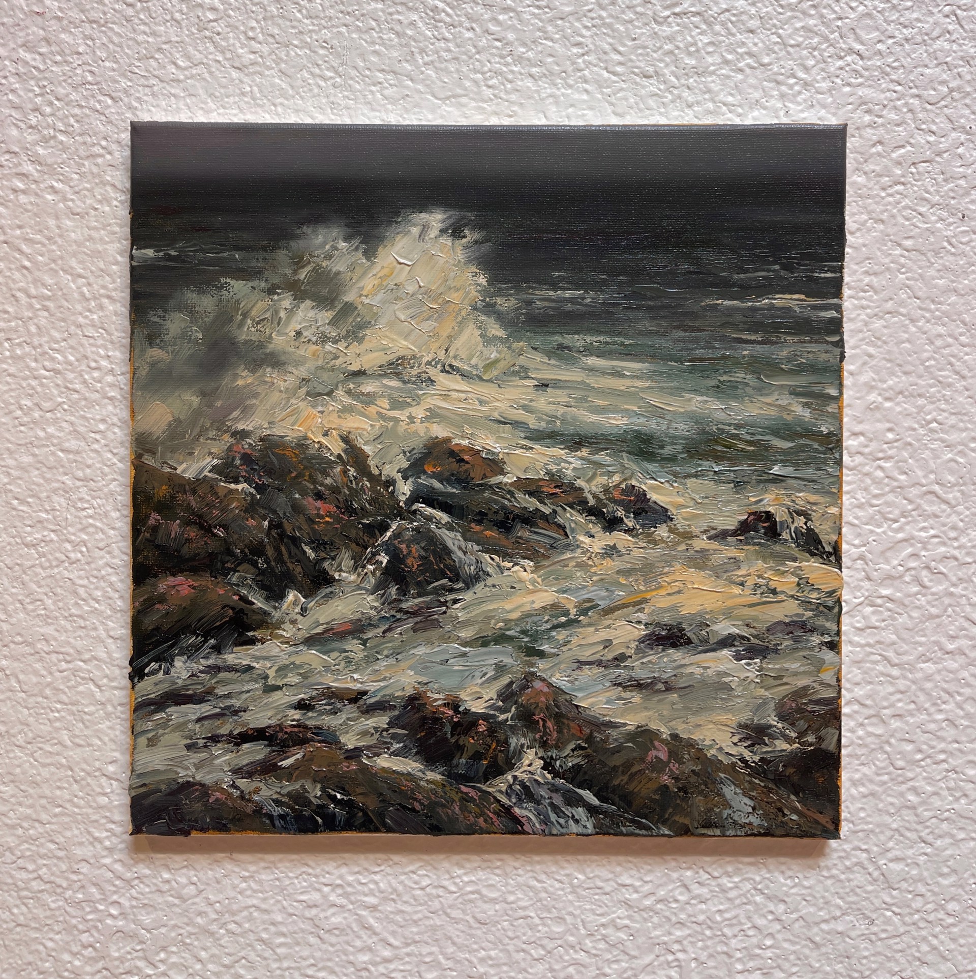A painting of waves crashing on rocks in the ocean.