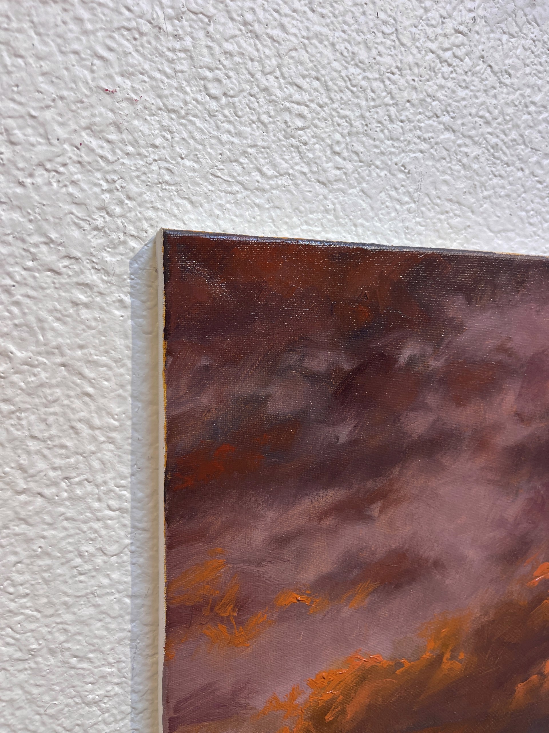 A painting of a sunset over a field of grass.