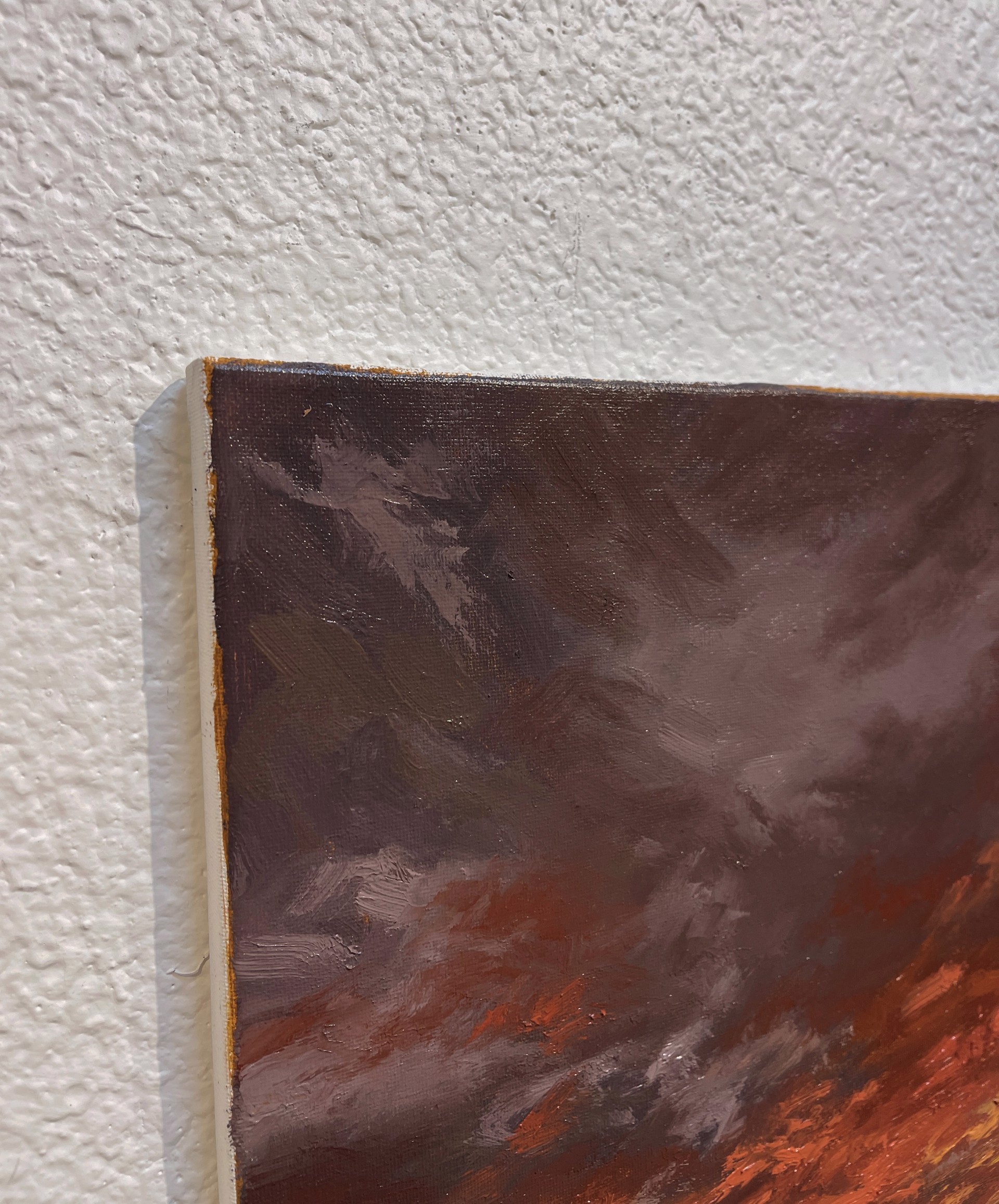A painting of a sunset over a field of grass.