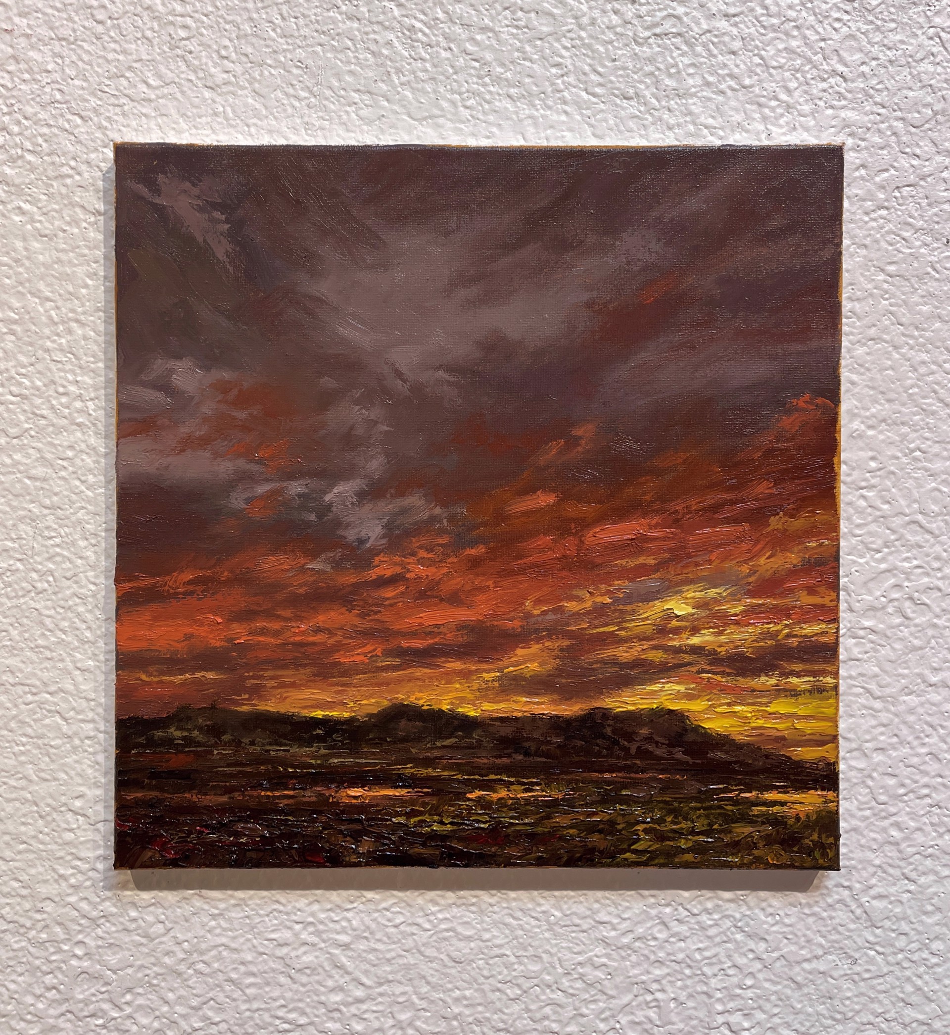 A painting of a sunset over a field of grass.