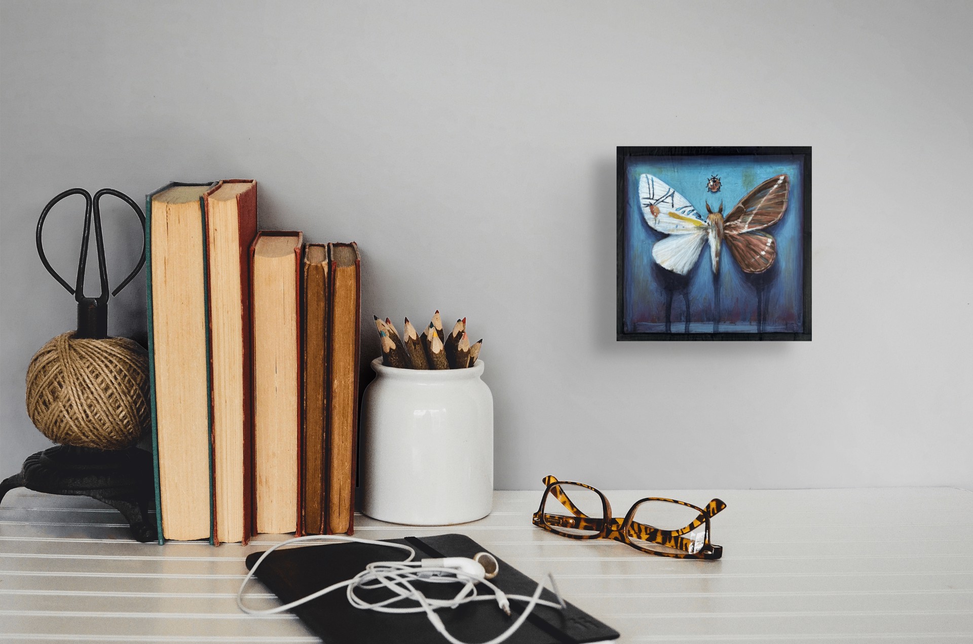 A painting of a moth and a ladybug on a blue background.