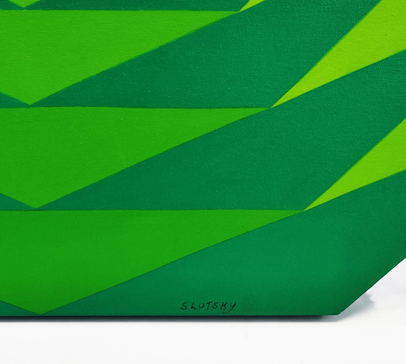 A green and yellow circular pattern on a white background.