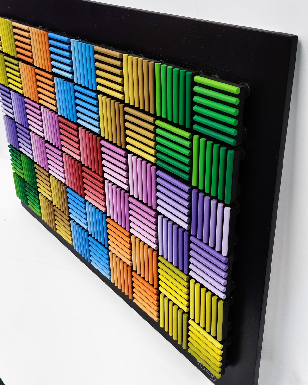 A painting of a colorful pattern of colored pencils on a black background.