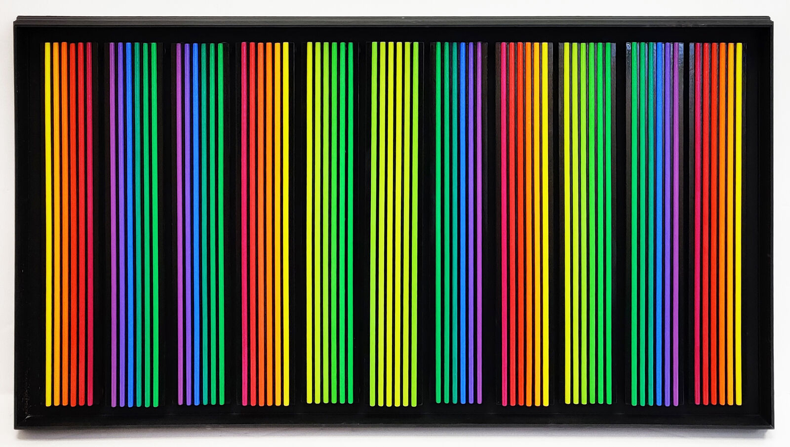 A black frame with a bunch of colored pencils on it.