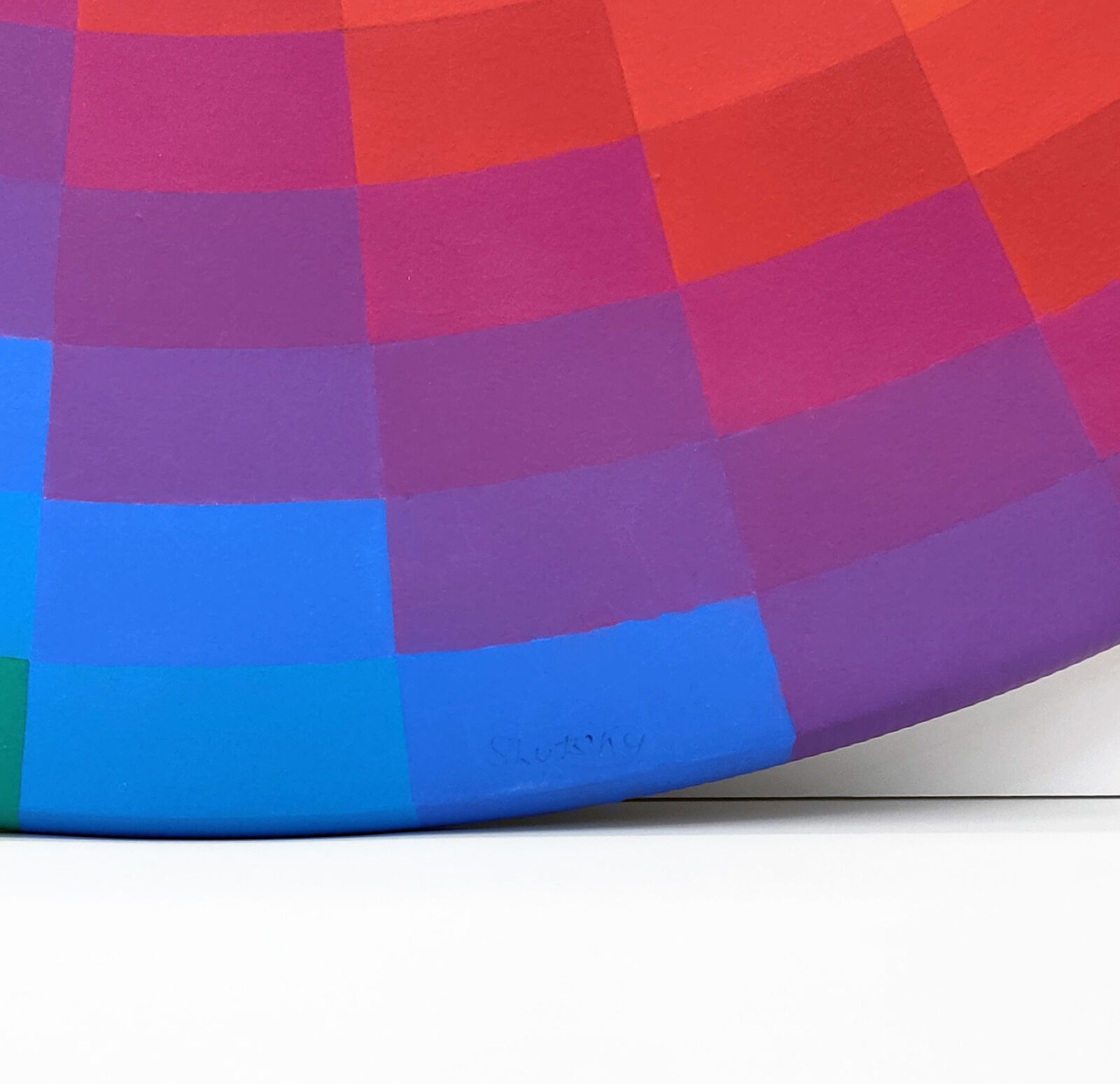 A rainbow colored circle on a white background.