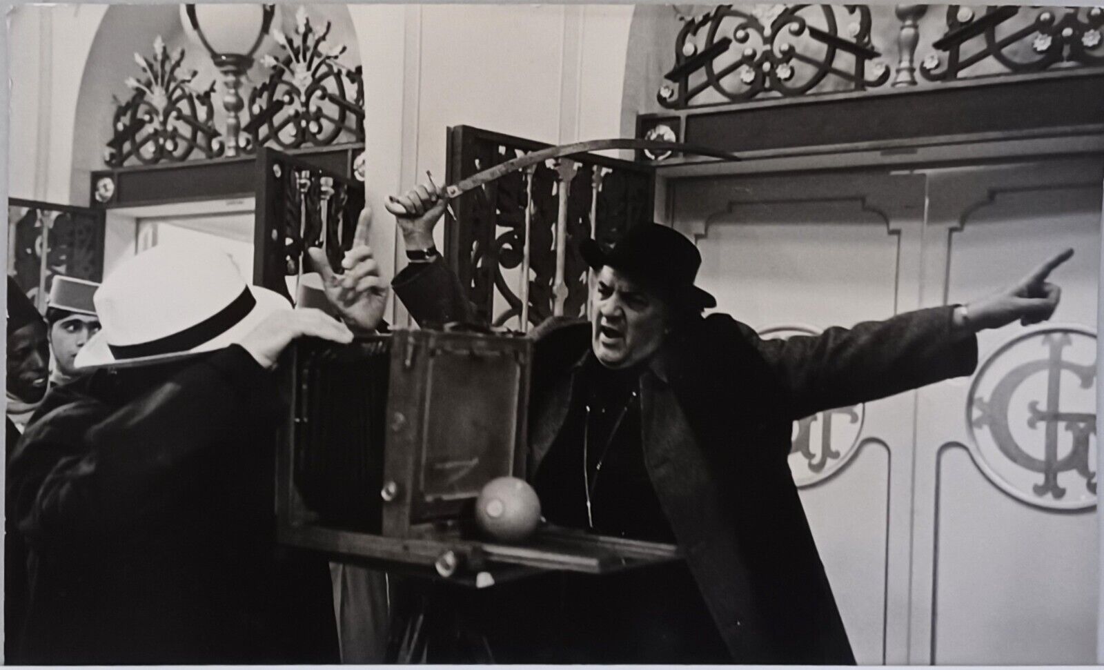 A black-and-white photograph capturing a tense moment between two figures in an ornate interior.