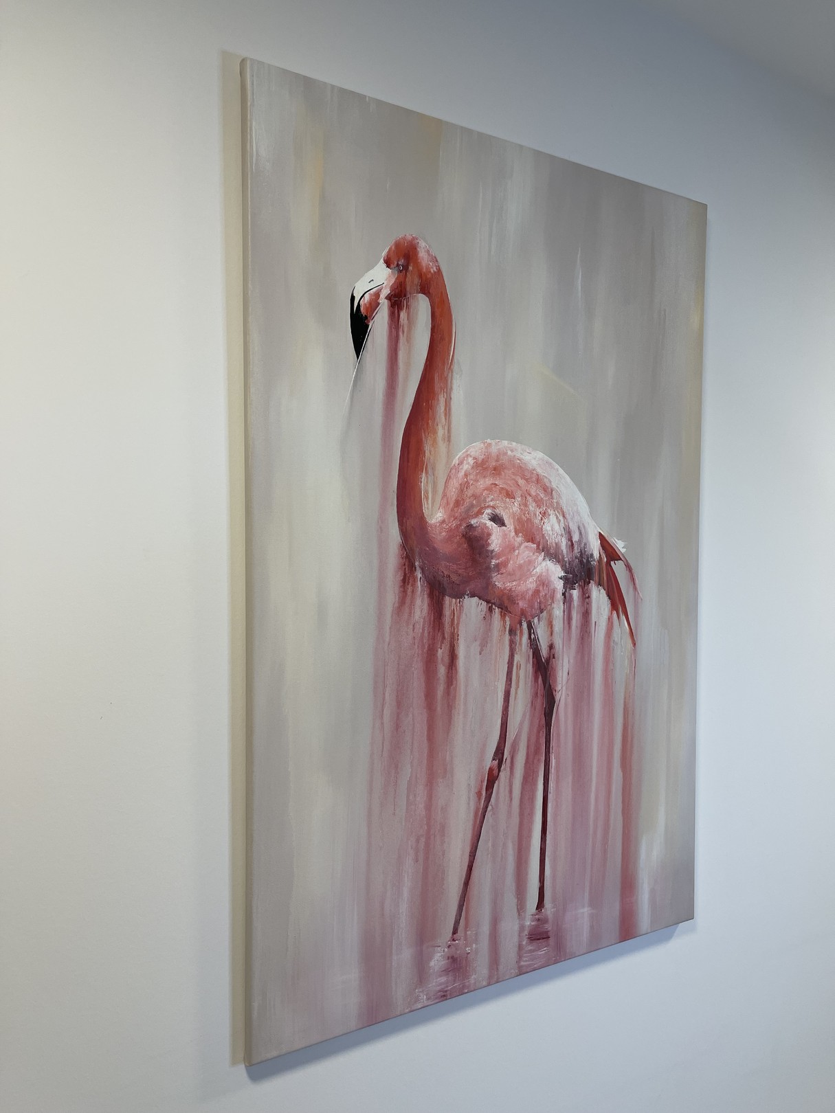A pink flamingo stands in a dreamy, dripping watercolor style against a soft background.