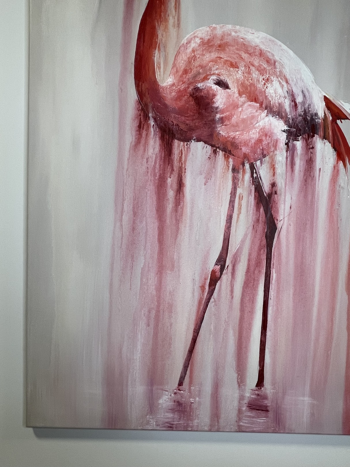 A pink flamingo stands in a dreamy, dripping watercolor style against a soft background.