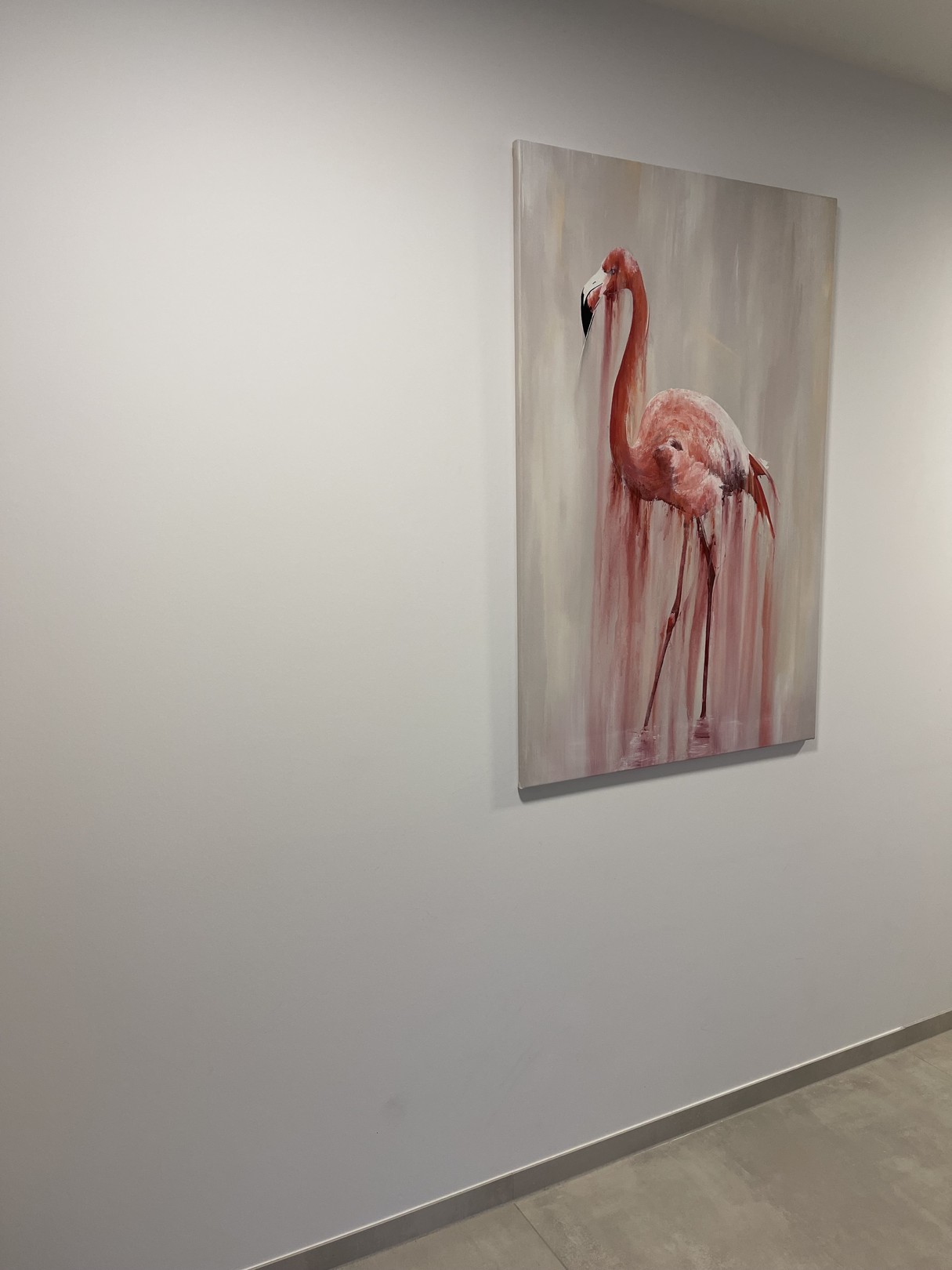 A pink flamingo stands in a dreamy, dripping watercolor style against a soft background.