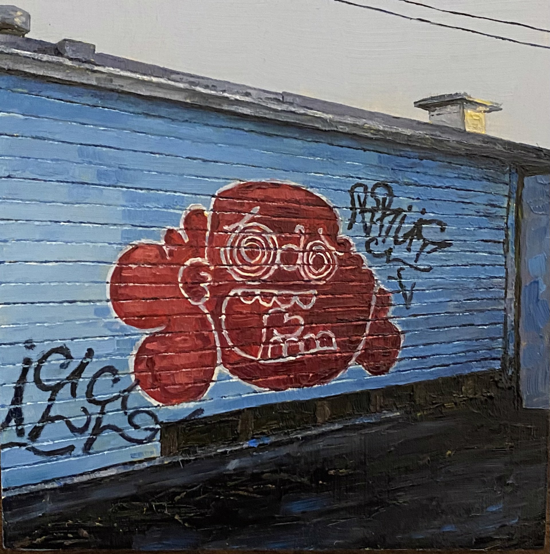 A blue garage door with graffiti on the side of it.
