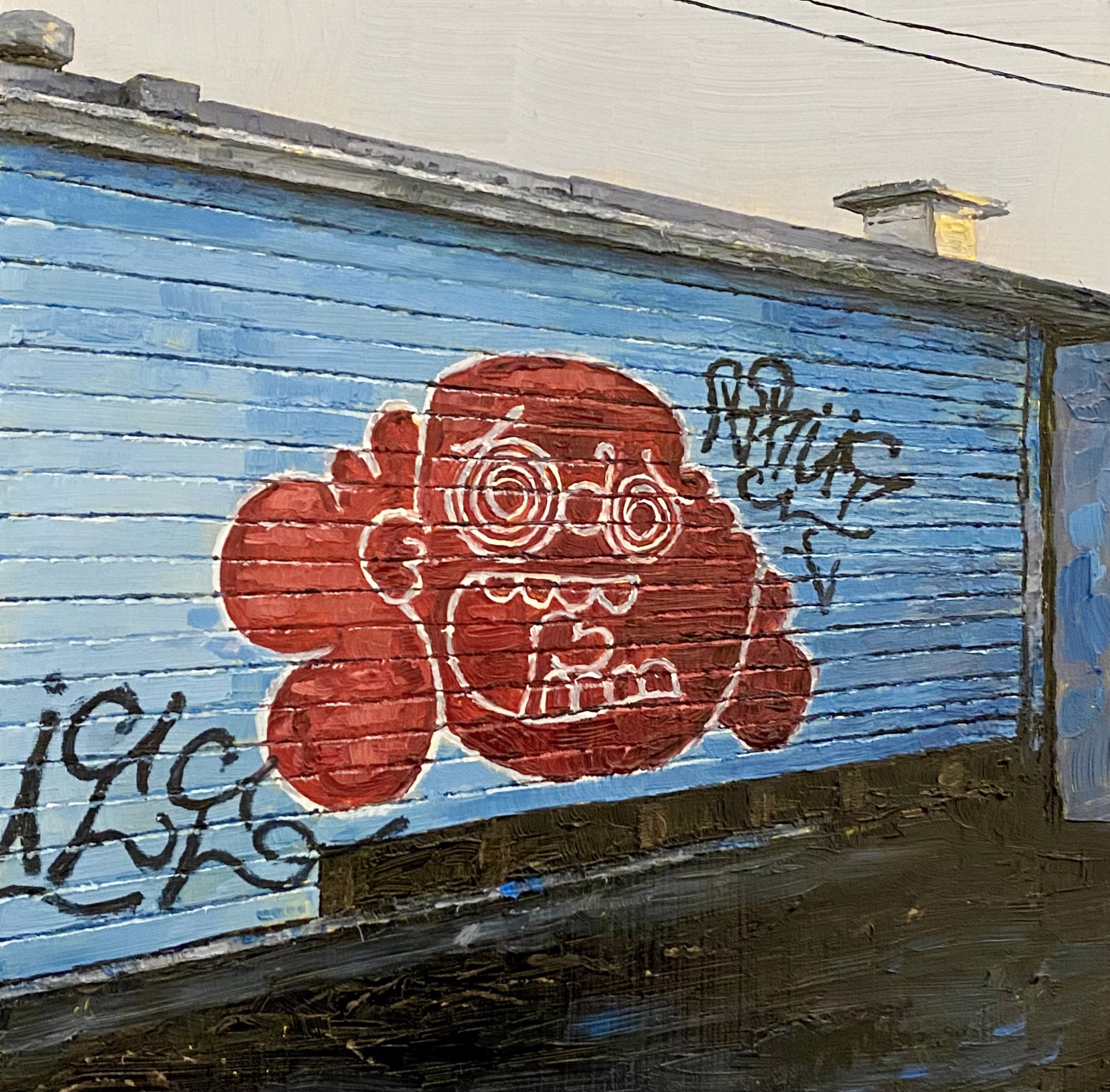 A blue garage door with graffiti on the side of it.