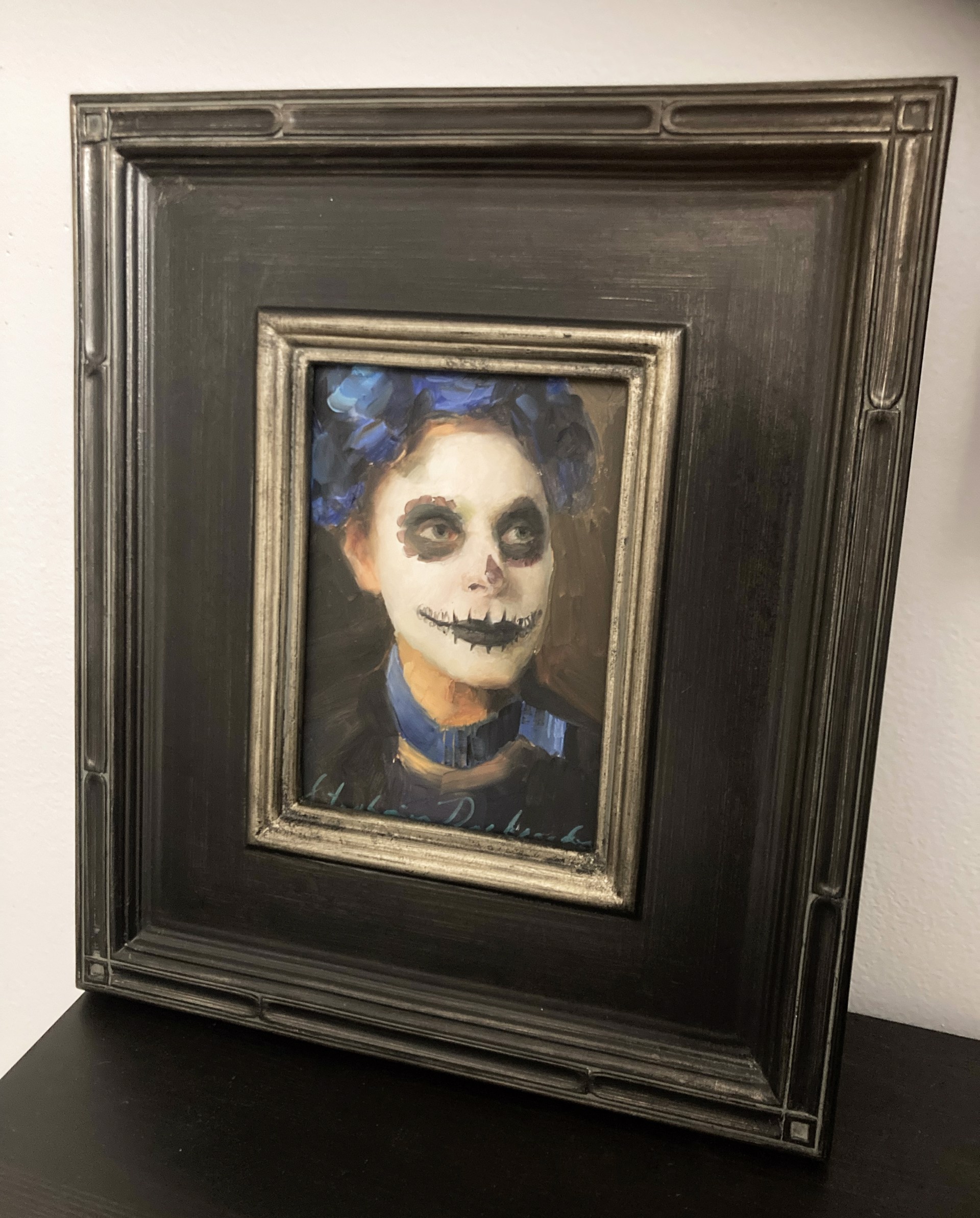 A painting of a woman with a skeleton face painted on her face.