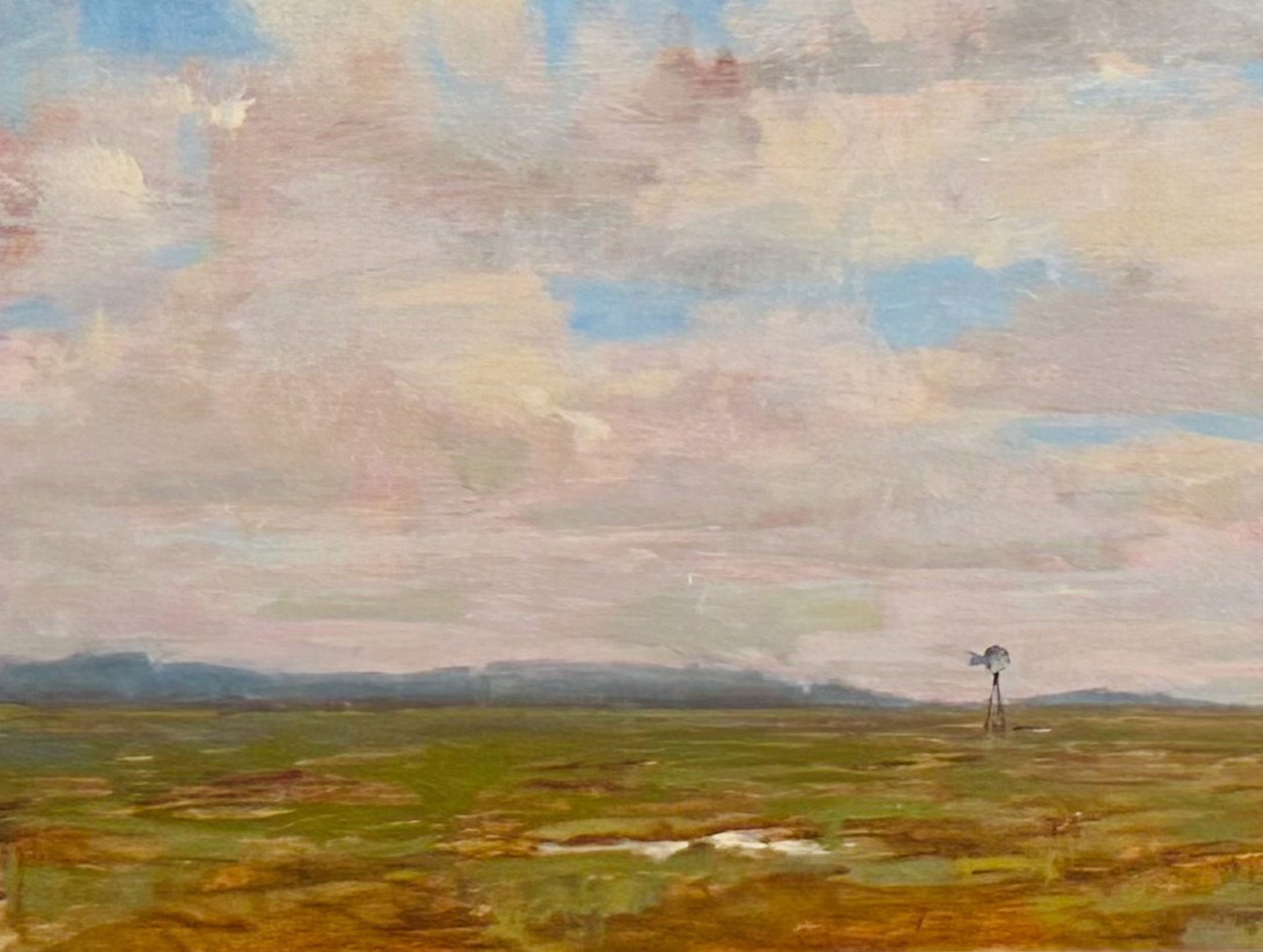 A painting of a field with a windmill in the distance.