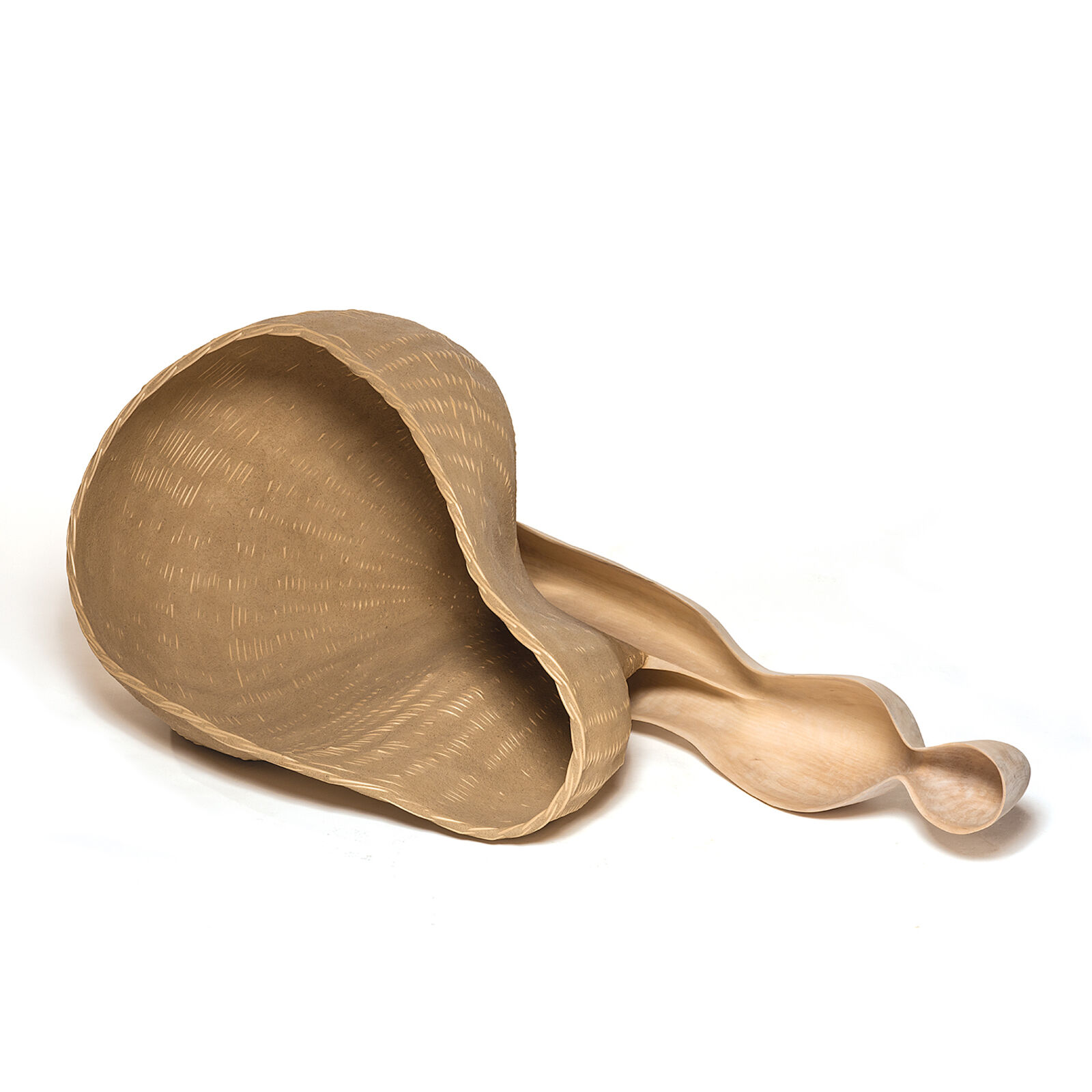 A wooden sculpture resembling a giant spoon resting on slate tiles.