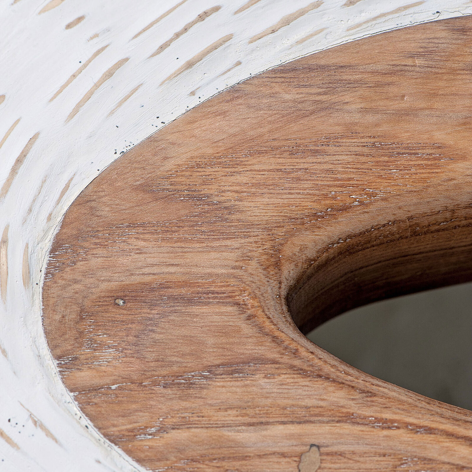 A textured white ceramic vessel with a wooden rim sits on a pedestal.
