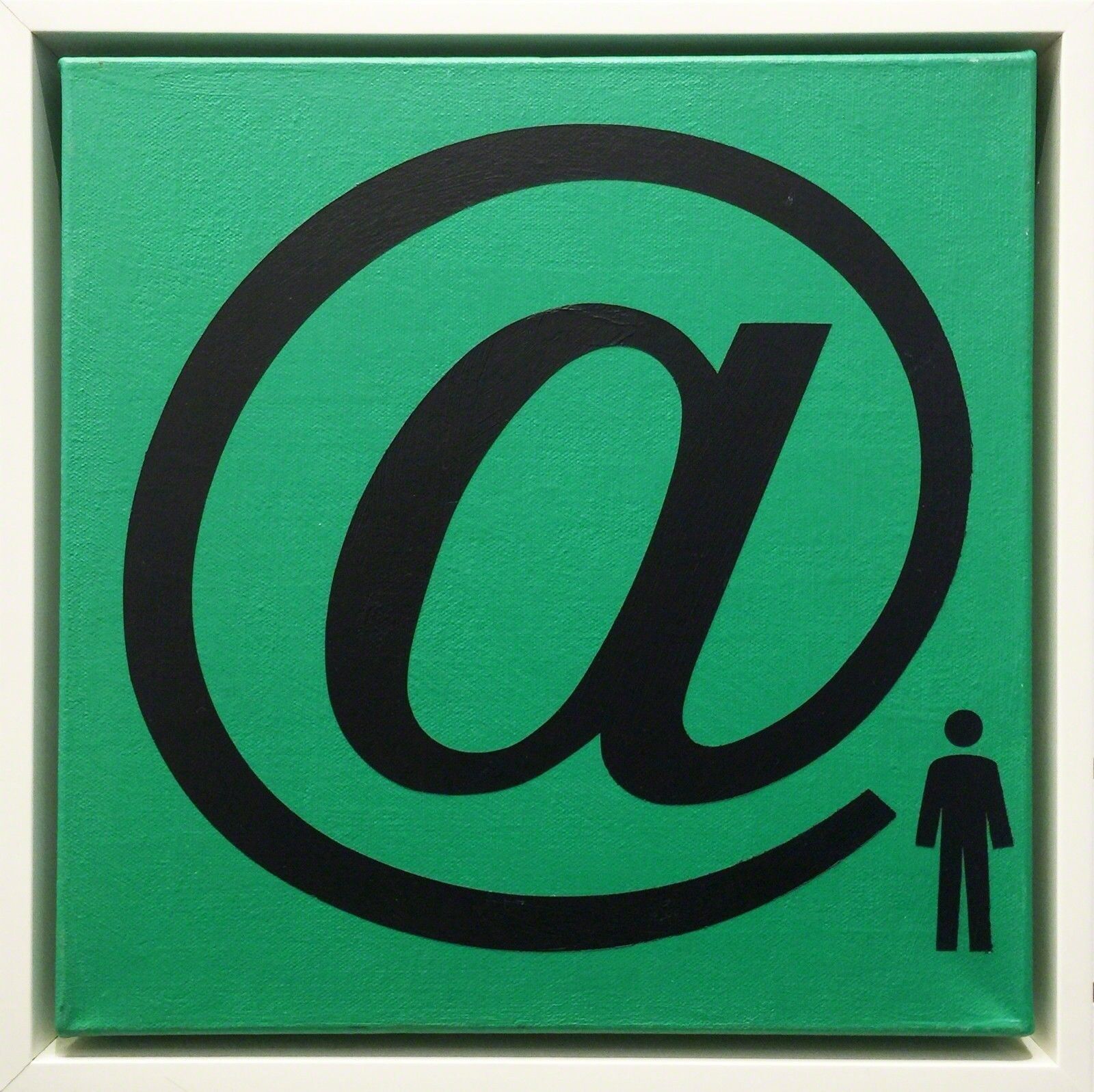 A green and black sign with an at symbol on it.