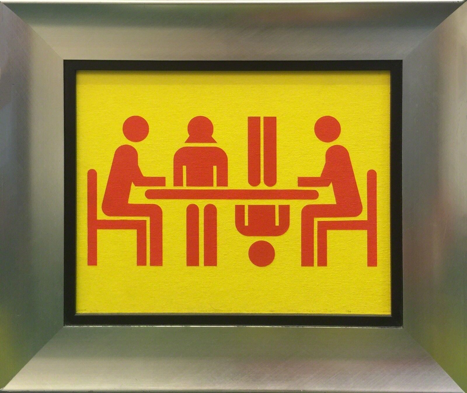 A picture of three people sitting at a table in a box.