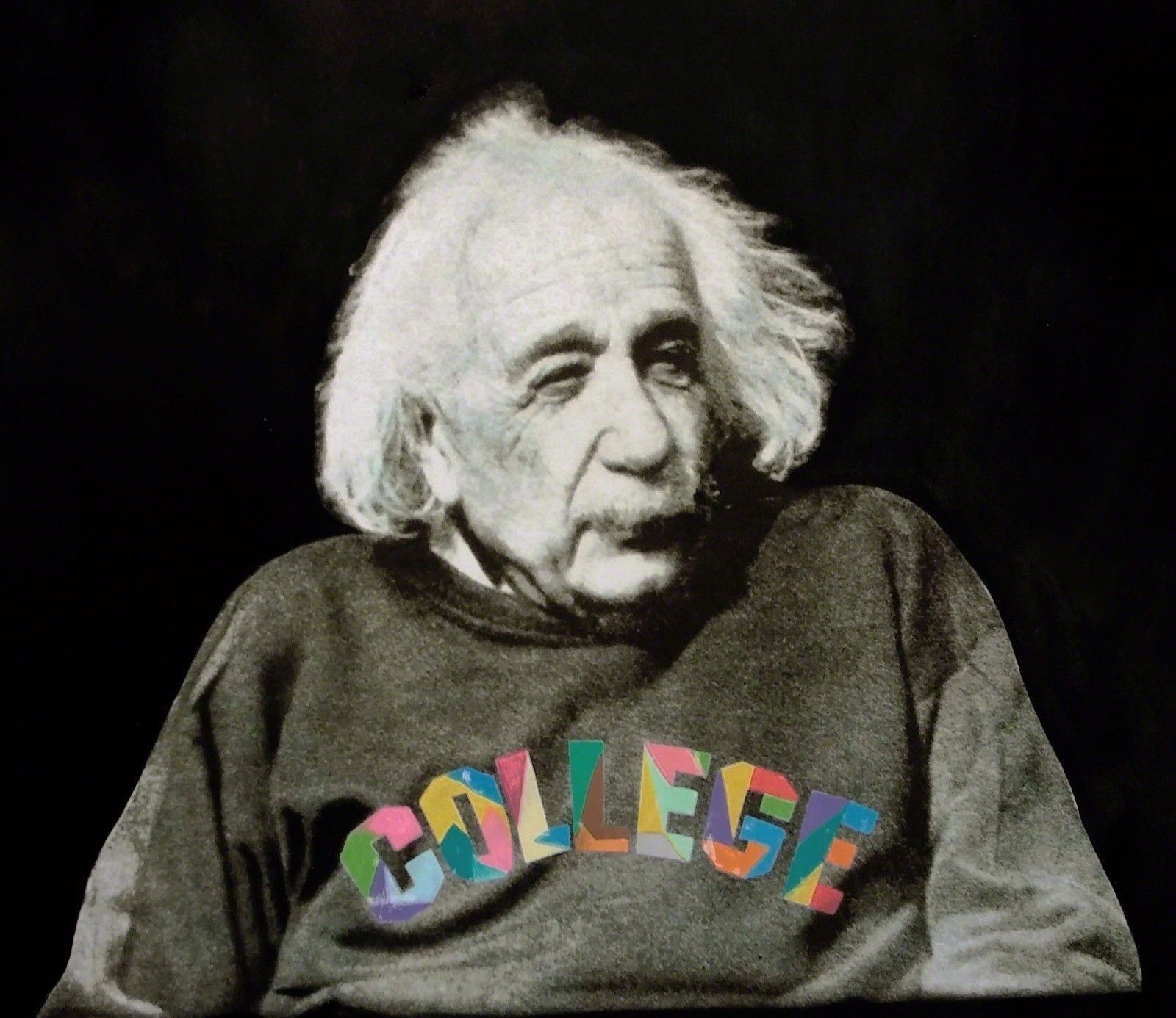 A black and white photo of a man wearing a sweatshirt that says college.