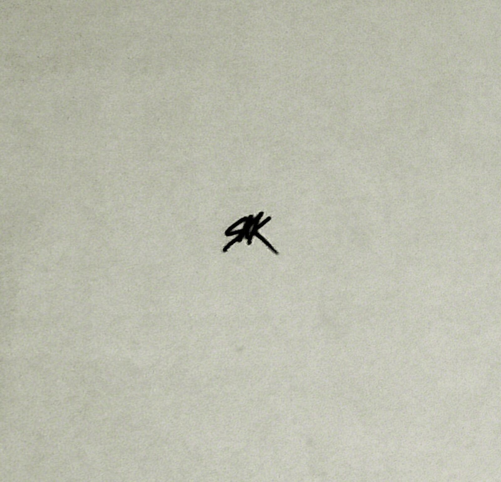 A black and white photo of a man wearing a sweatshirt that says college.