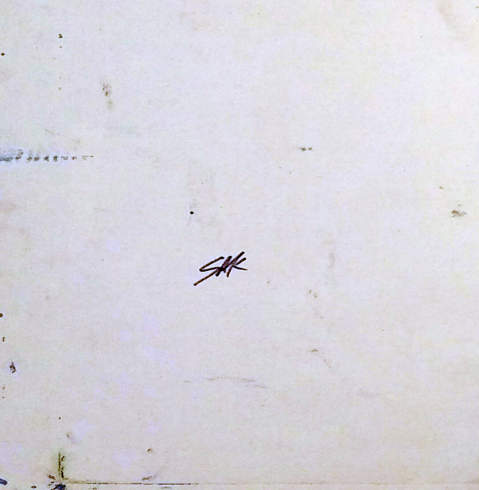 A group of men standing in front of a sign.