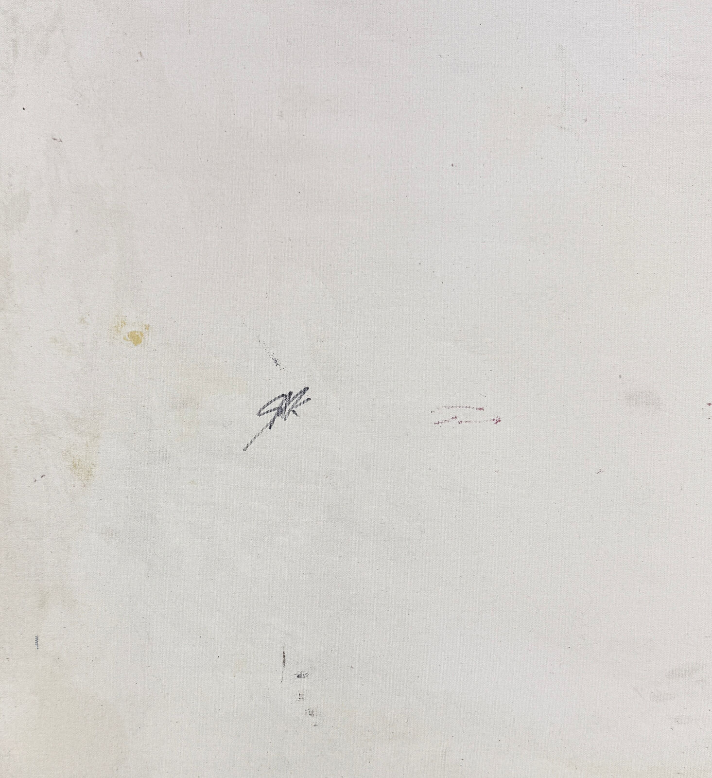 A woman in a red dress sitting on the ground in front of a Hollywood sign.