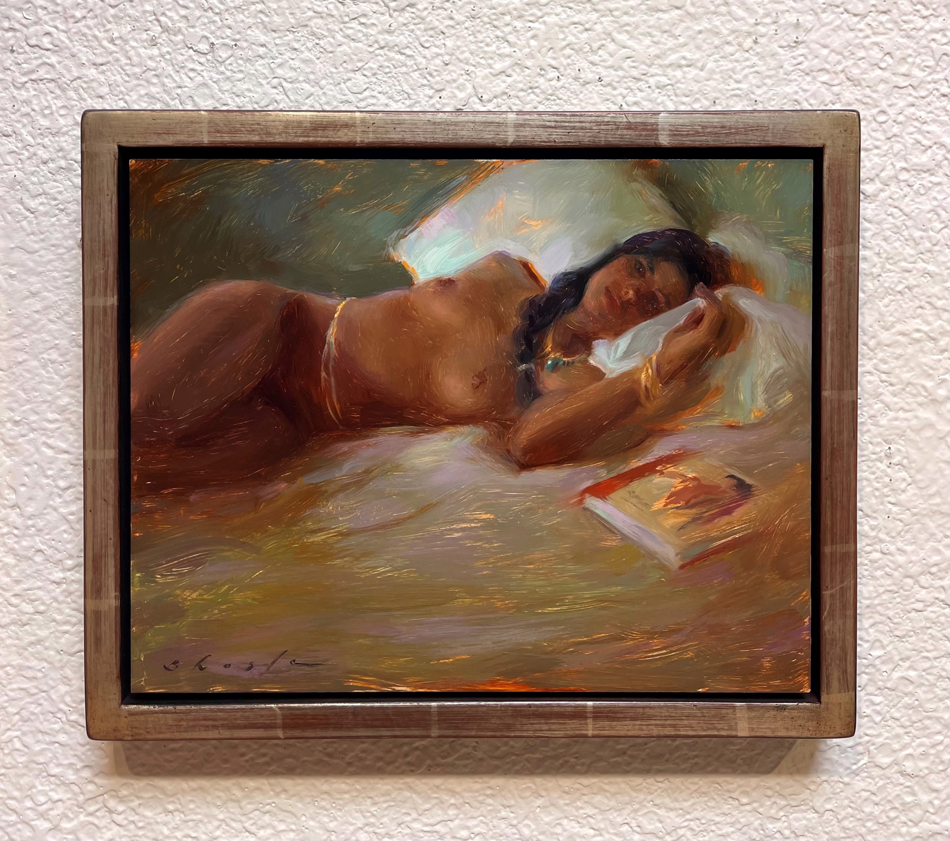 A painting of a woman laying on a bed reading a book.