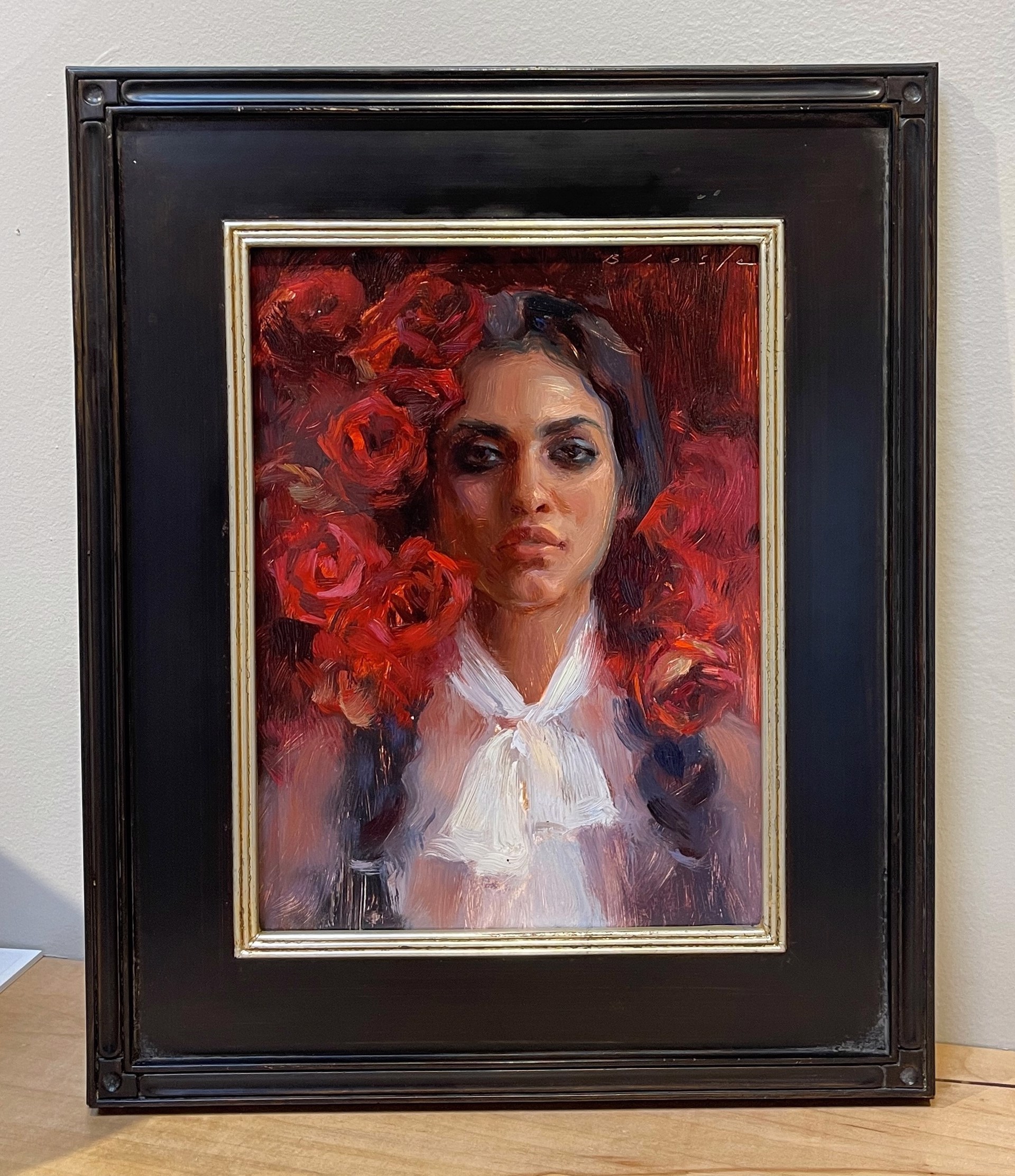 A painting of a woman with red roses in her hair.