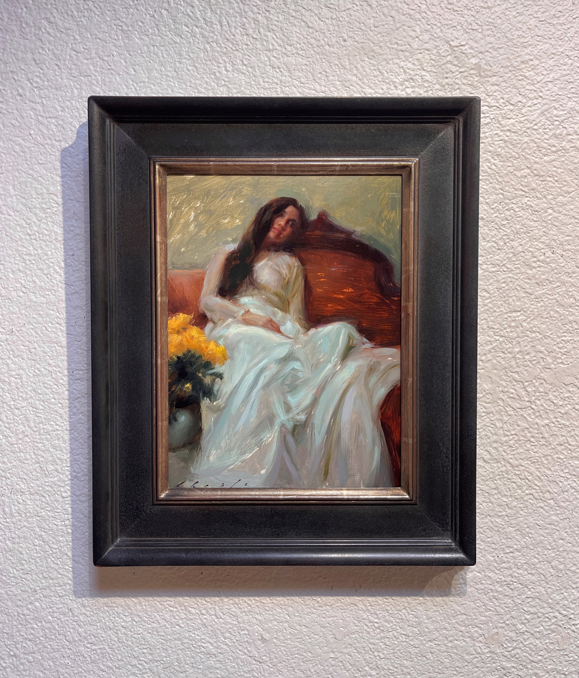 A painting of a woman sitting on a couch with a vase of flowers.