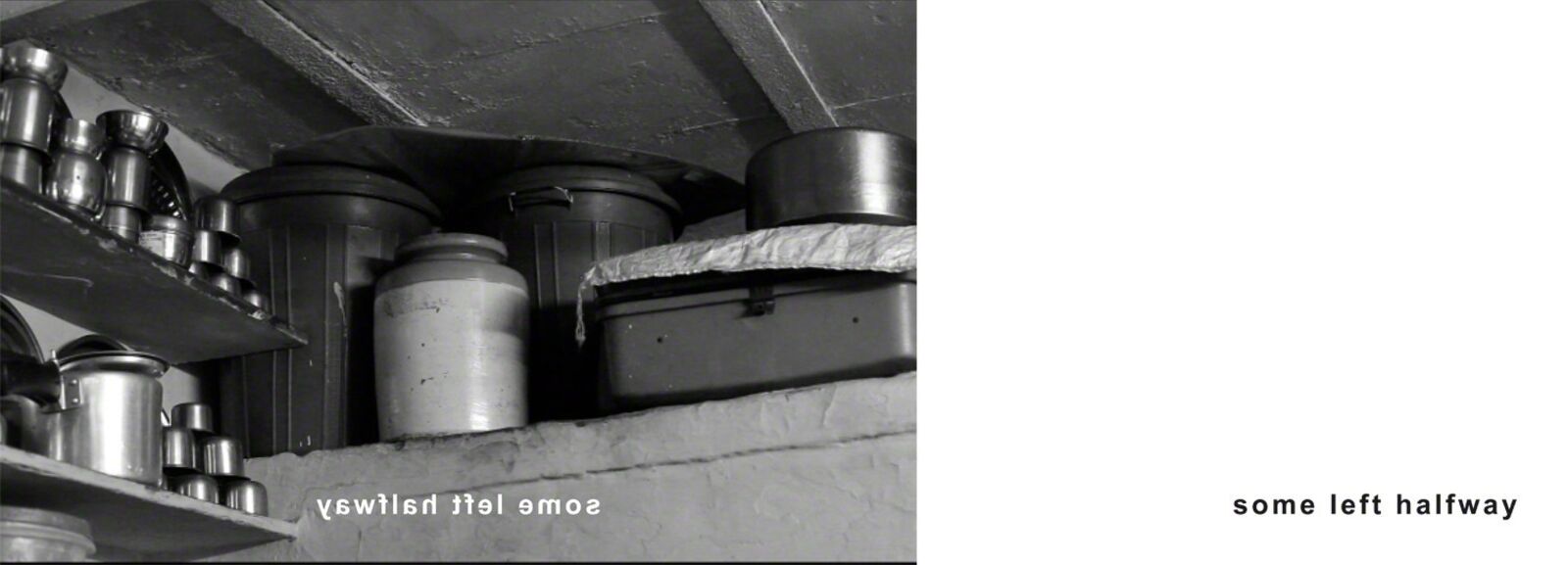 A black and white photo of a shelf filled with pots and pans.