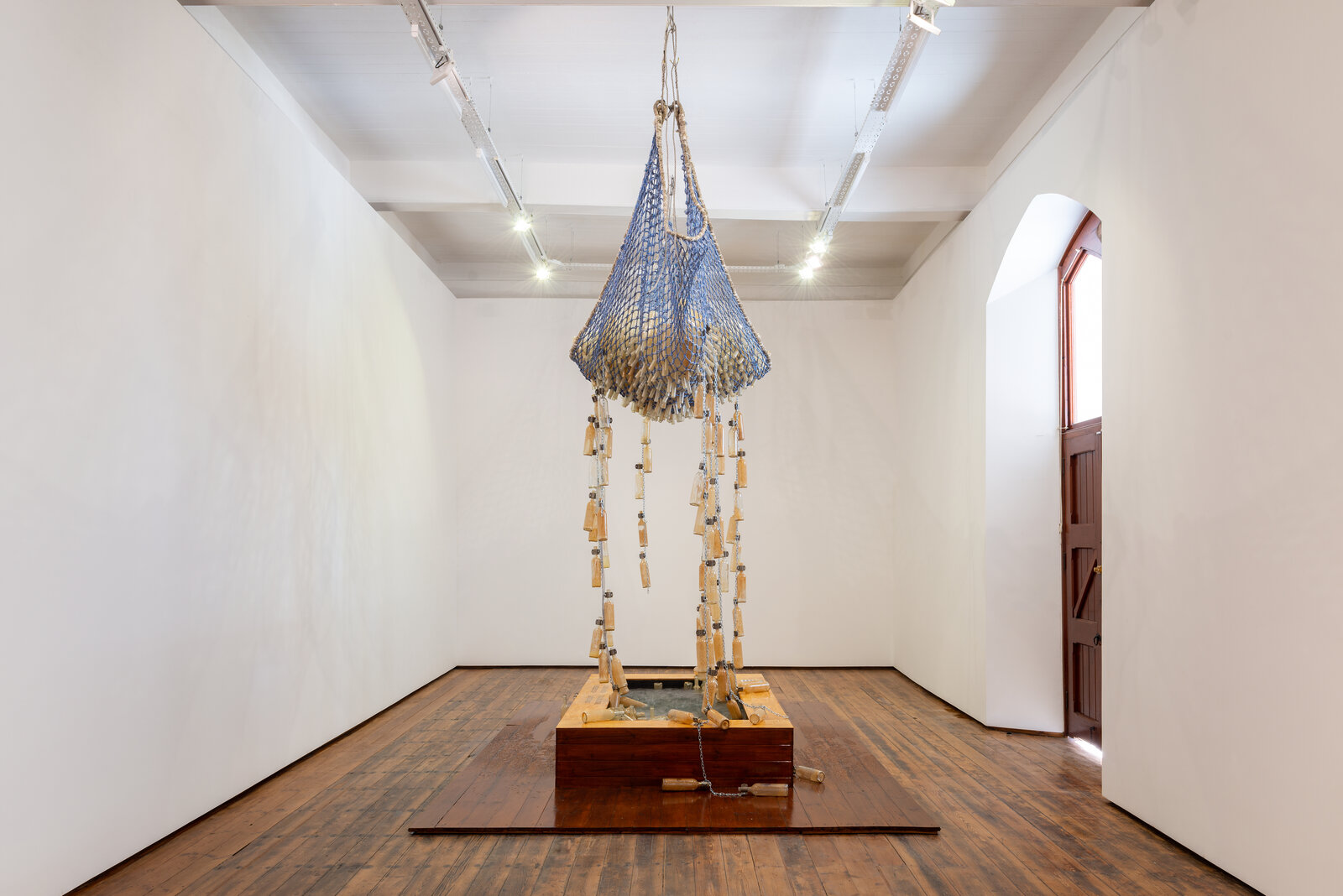A large blue and white sculpture hanging from the ceiling in a room.