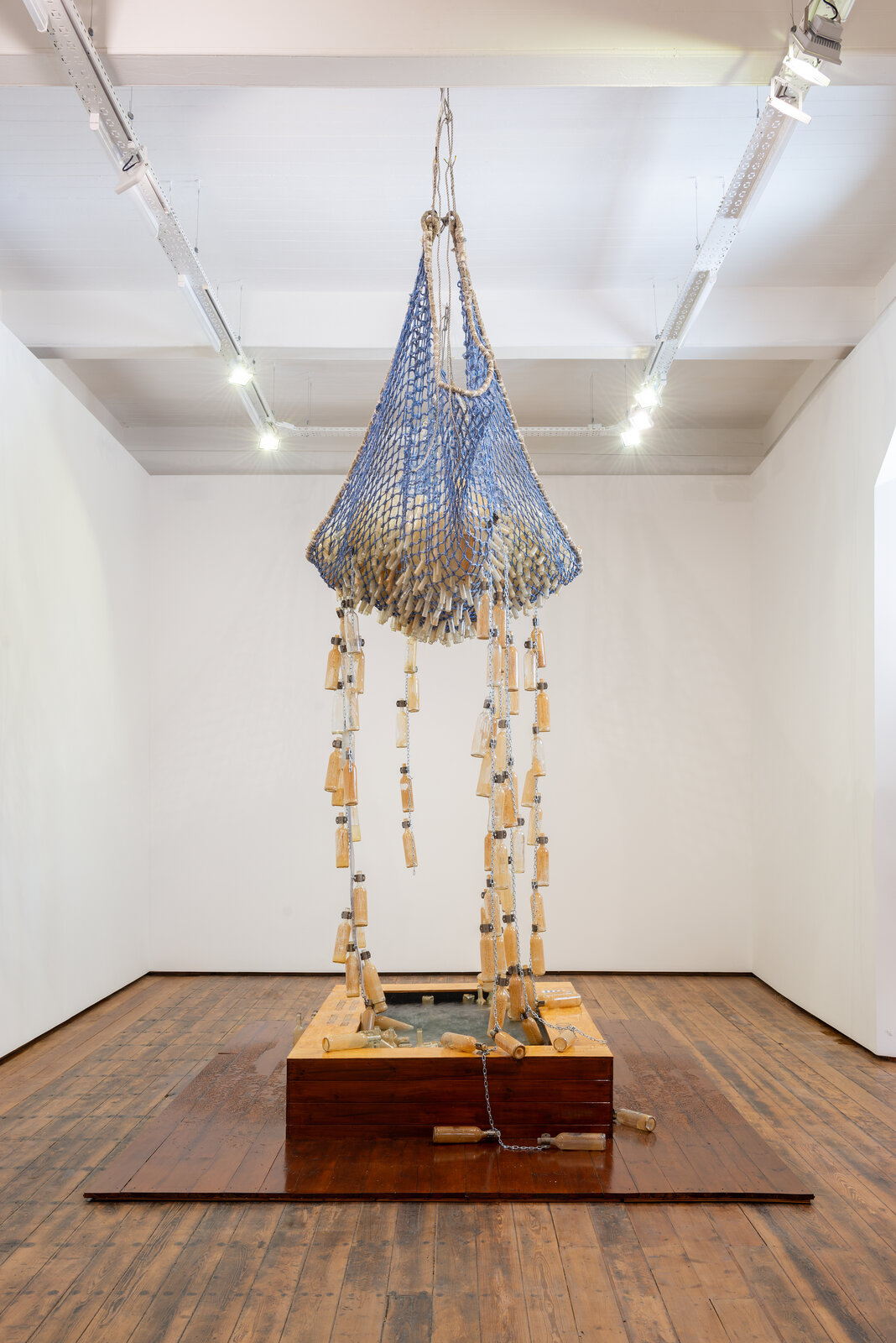 A large blue and white sculpture hanging from the ceiling in a room.