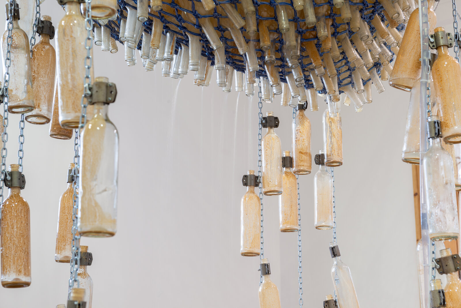 A large blue and white sculpture hanging from the ceiling in a room.