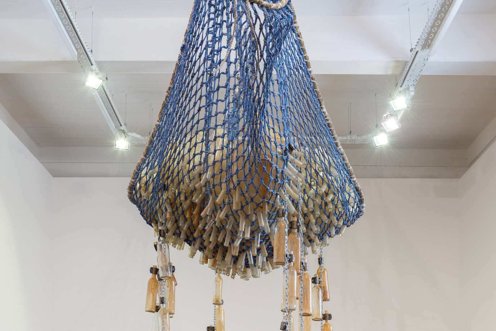 A large blue and white sculpture hanging from the ceiling in a room.