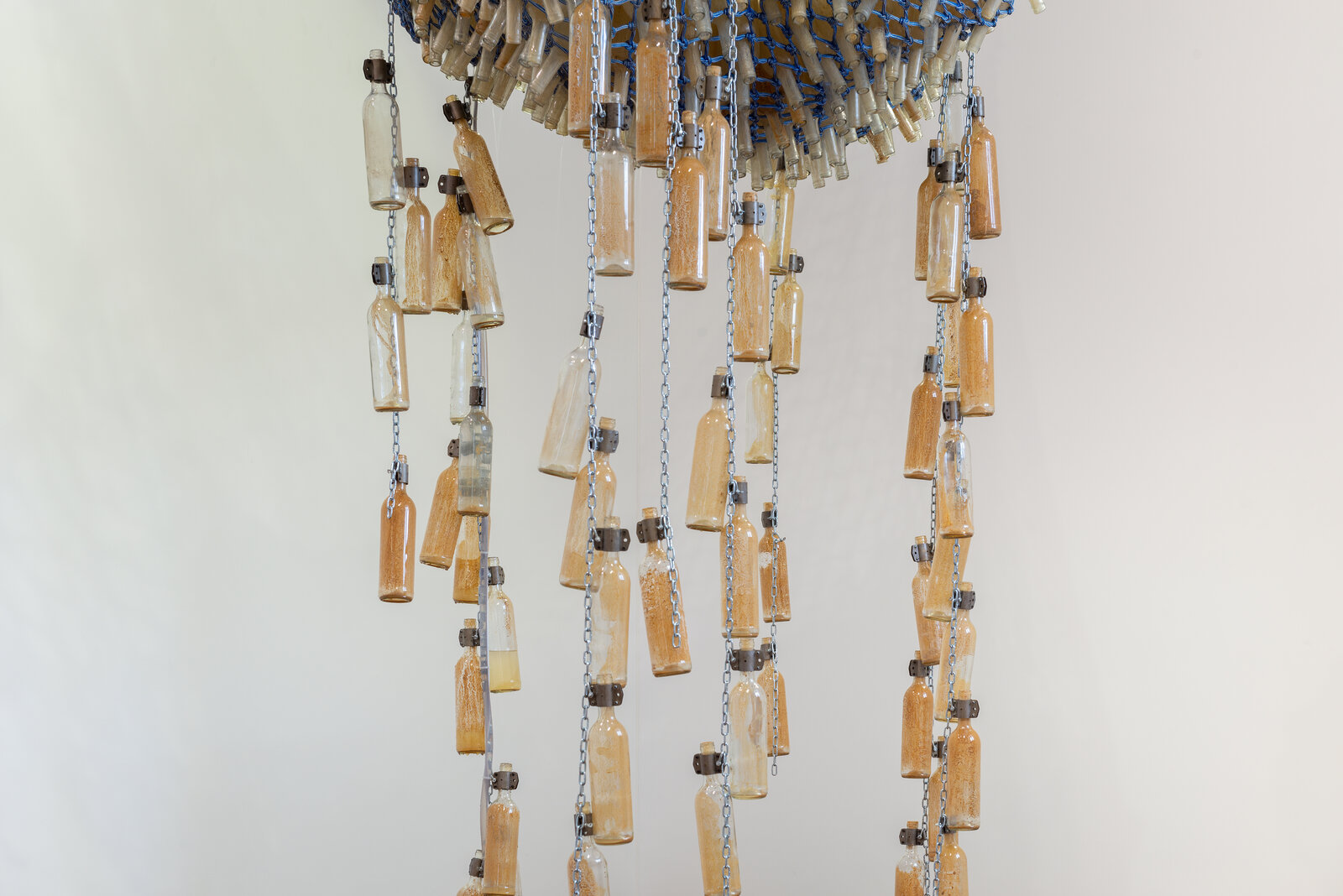 A large blue and white sculpture hanging from the ceiling in a room.