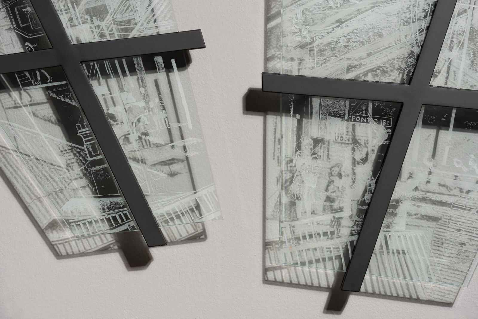 A pair of black and white photographs hanging on a wall.