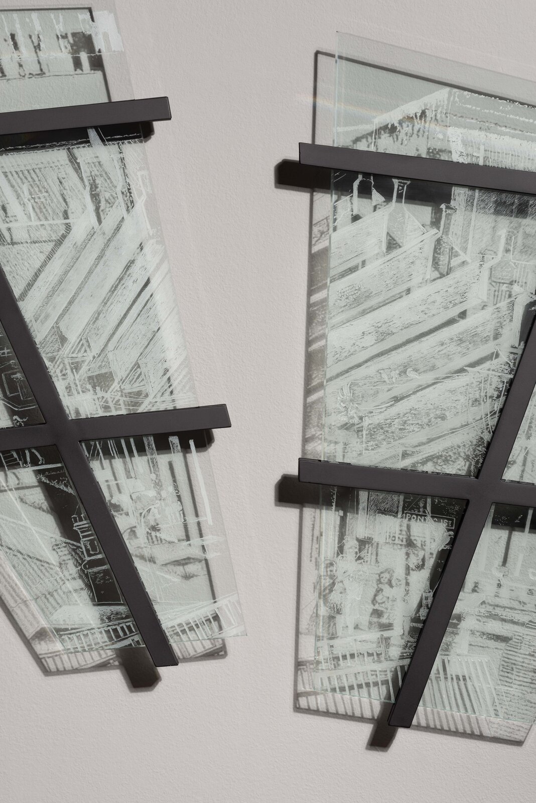 A pair of black and white photographs hanging on a wall.