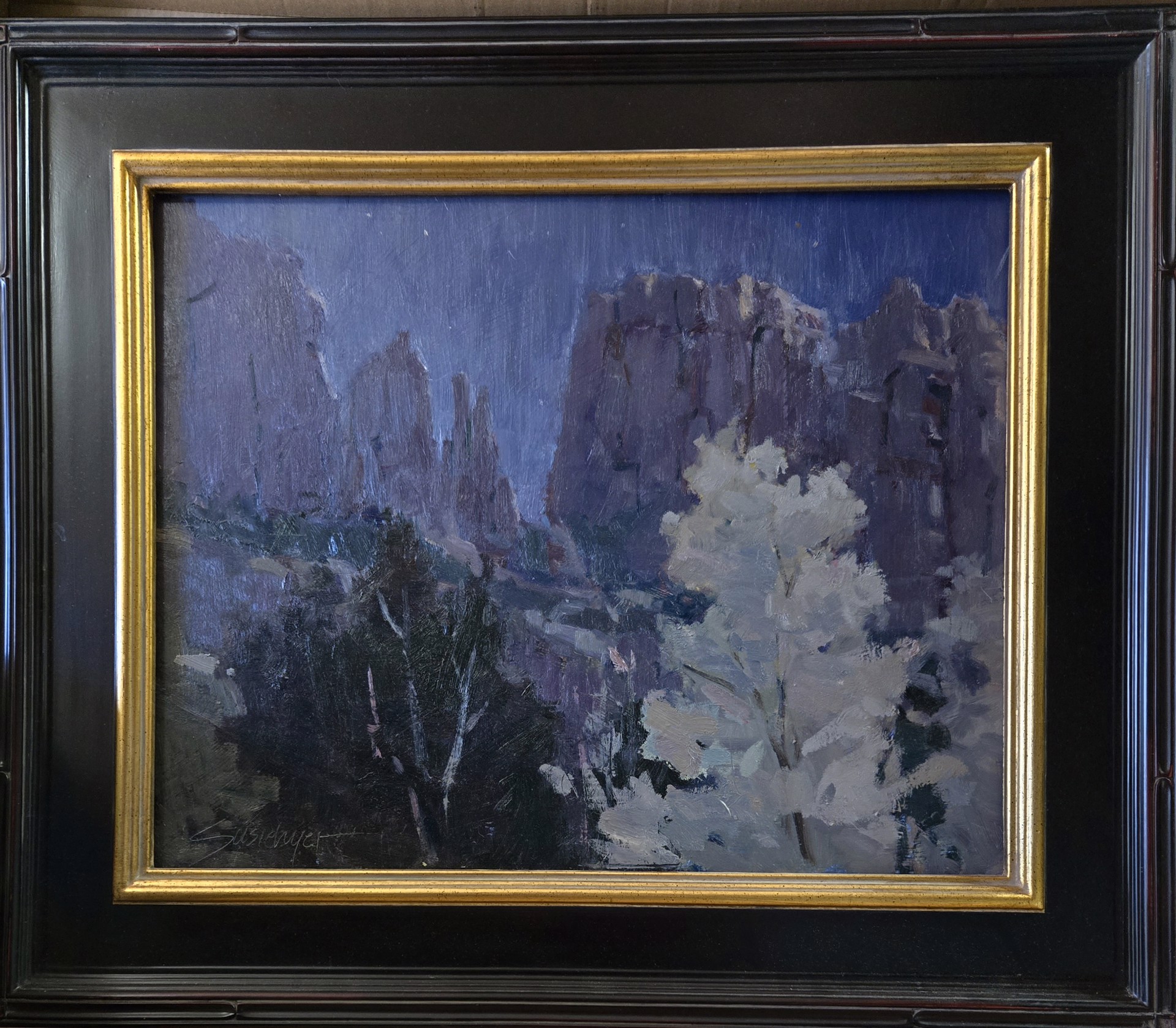 A painting of a tree in front of a mountain range.