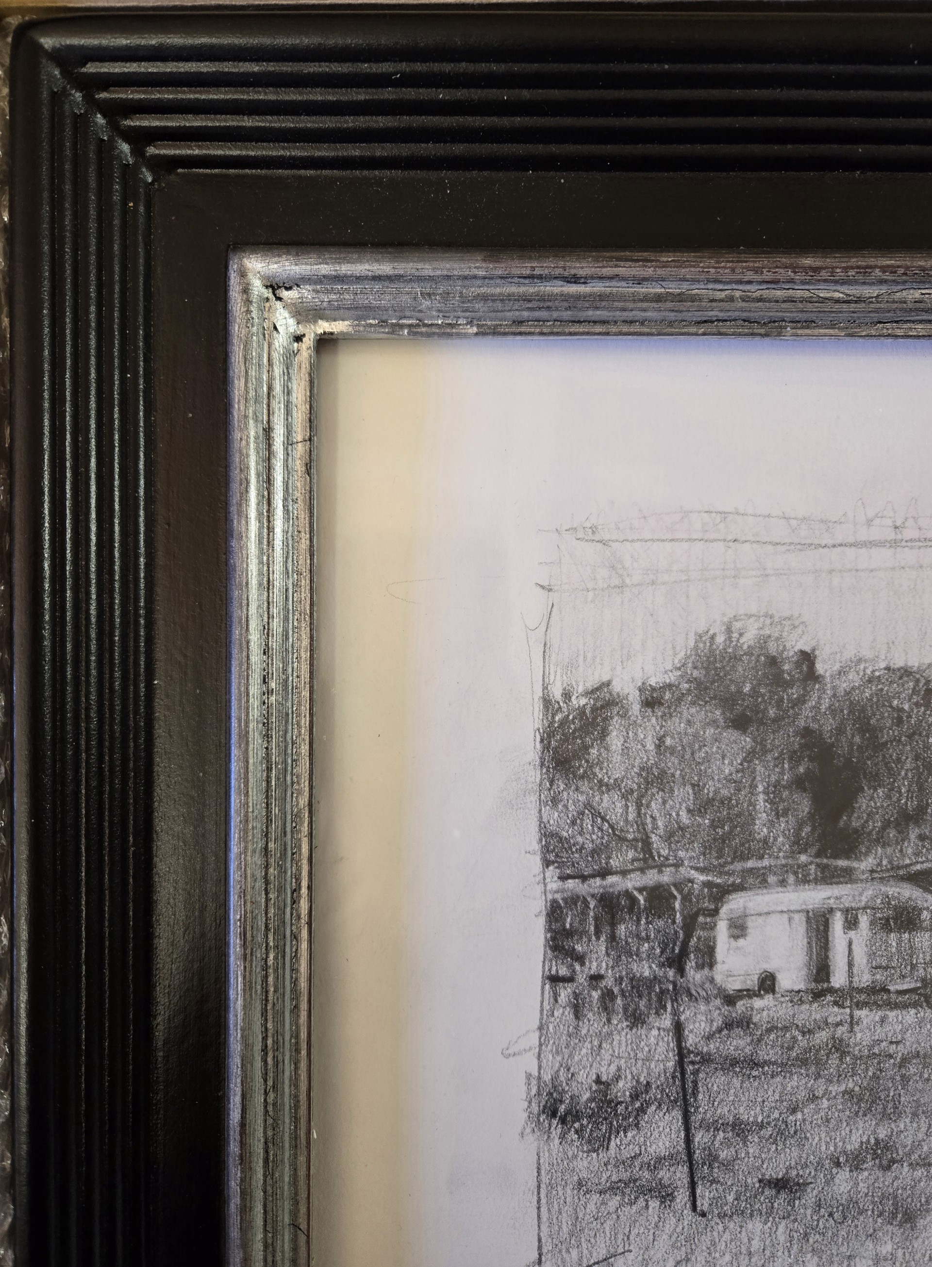 A monochromatic pencil sketch of a rustic rural scene featuring an old trailer and weathered structures.