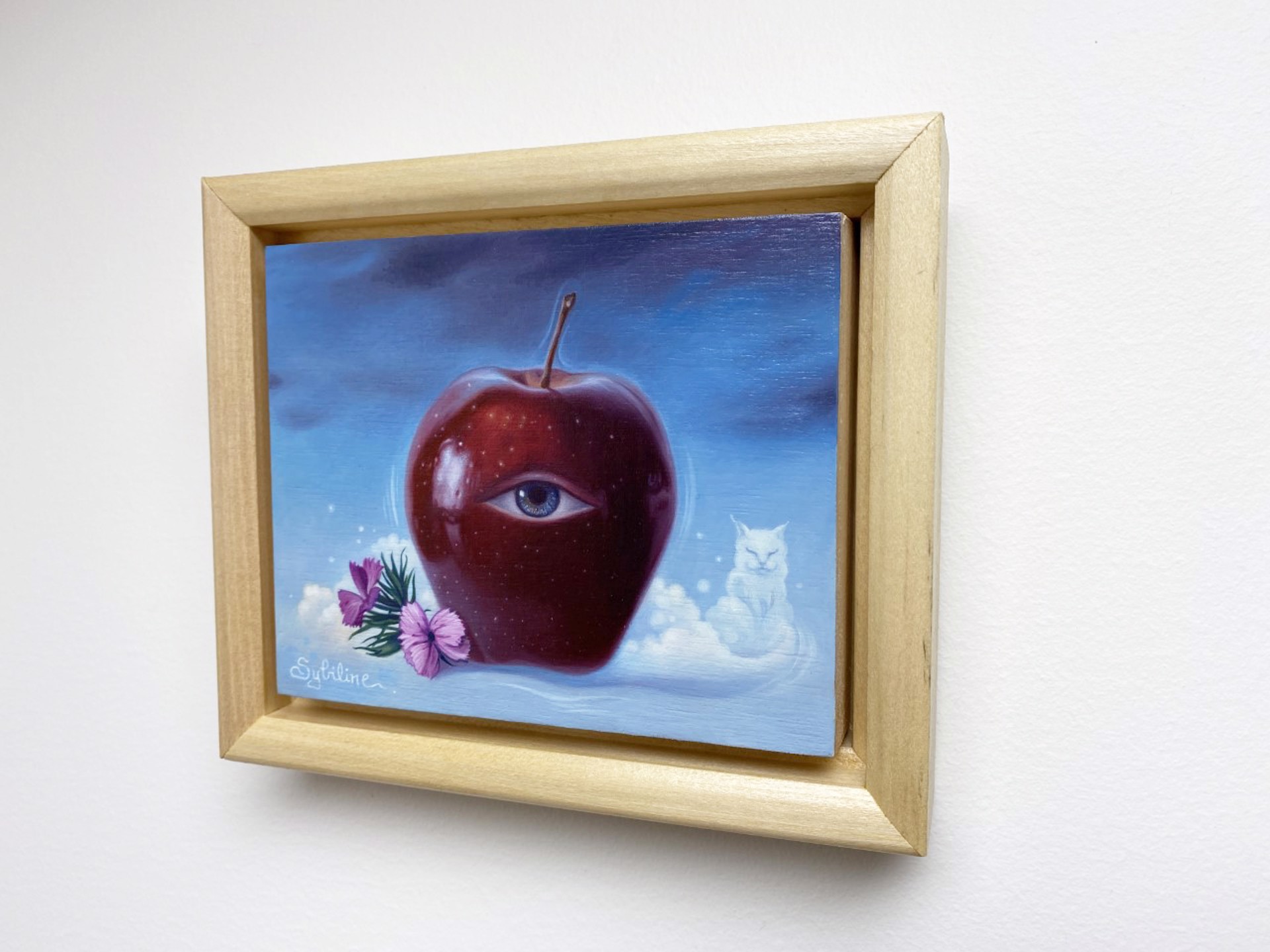 A painting of an apple with an eye and a cat in the sky.