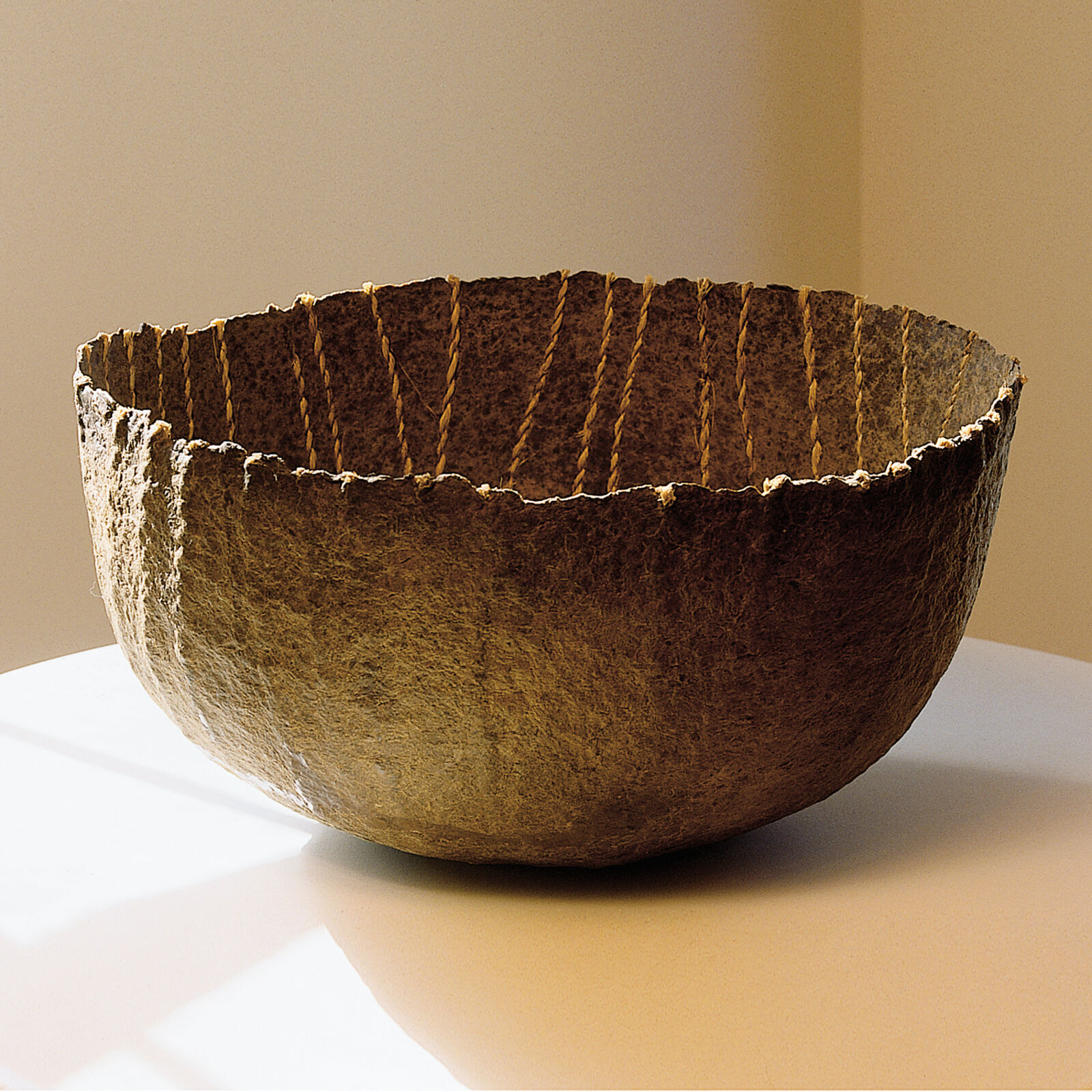 A large bowl sitting on top of a white table.