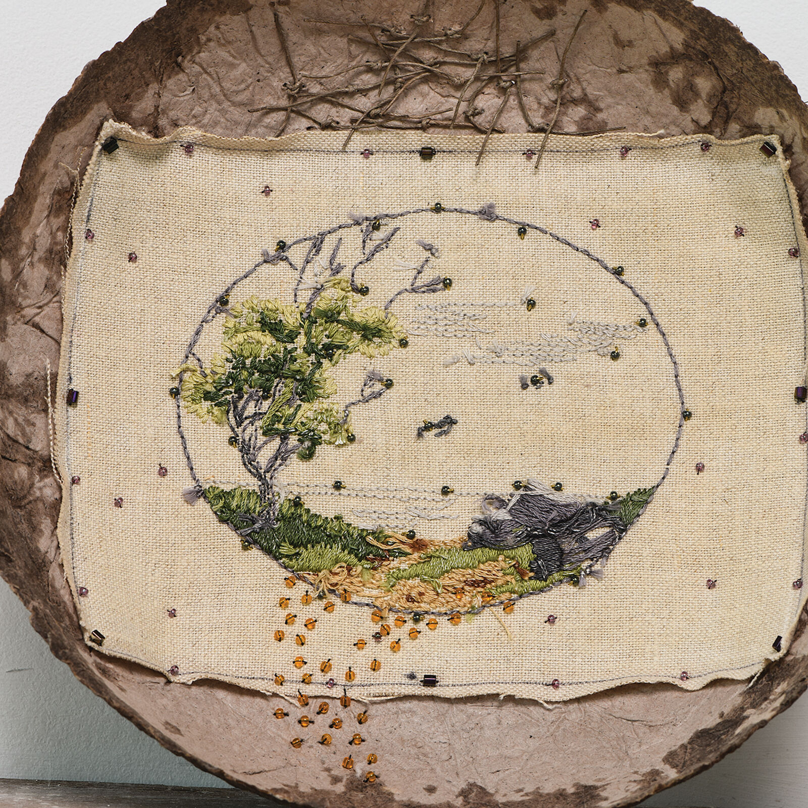A brown bowl with writing on it sitting on a shelf.