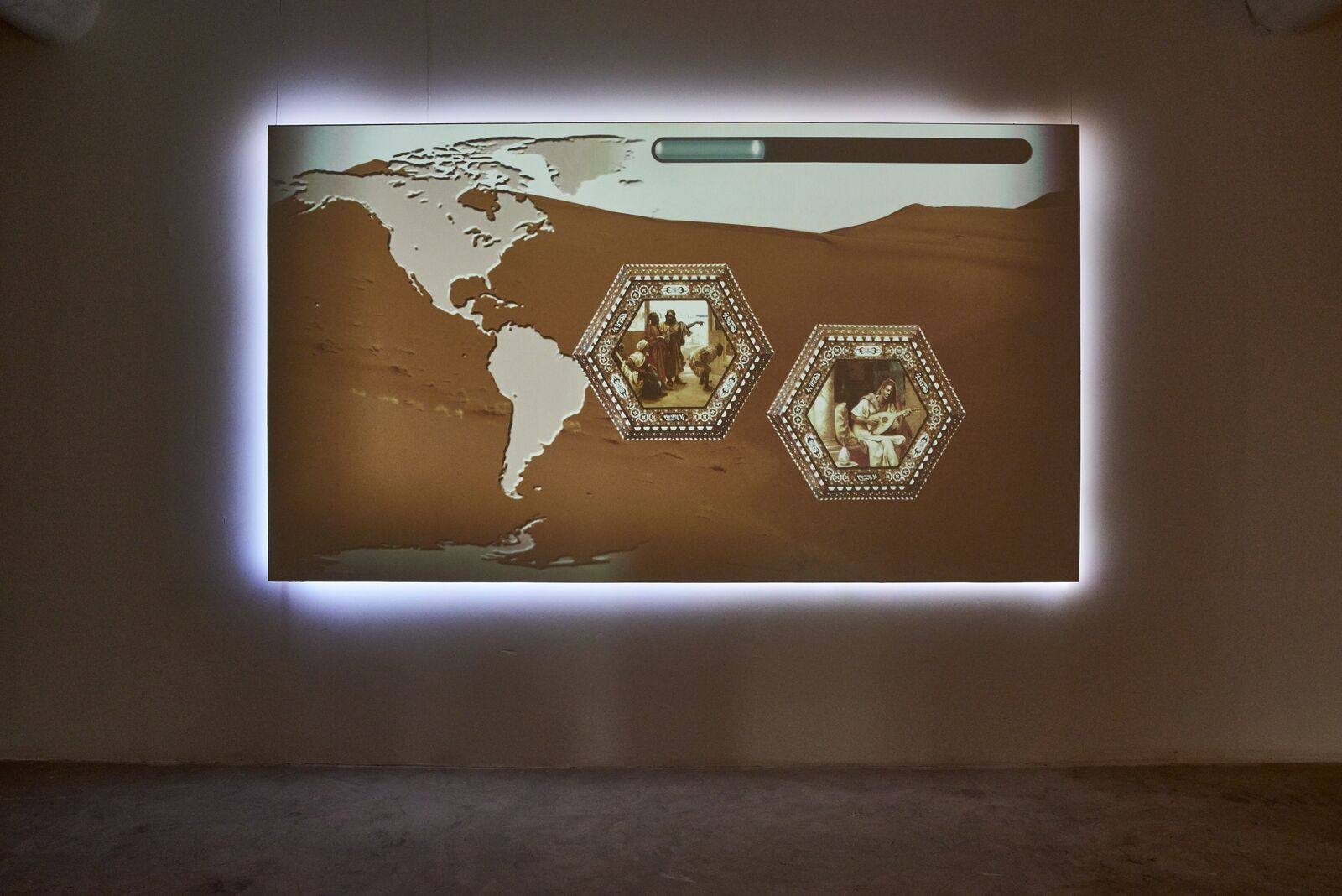 A picture of a map of the world on a wall in a room.