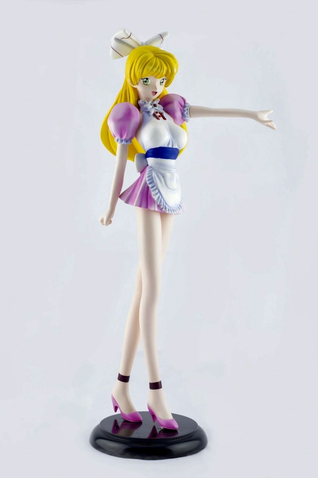 A figurine of a woman in a pink dress and white apron.