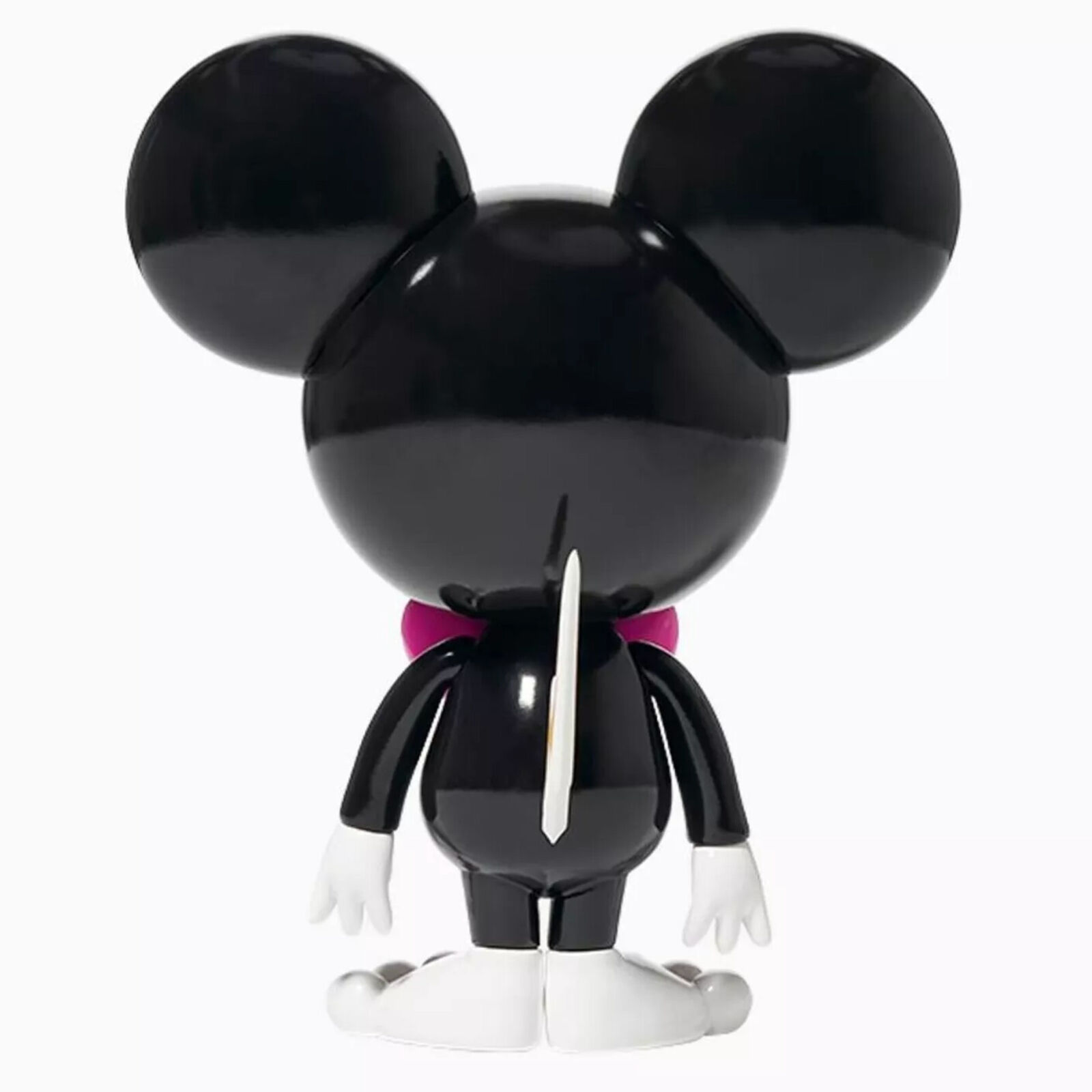 A toy figure of a mickey mouse with a pink bow tie.