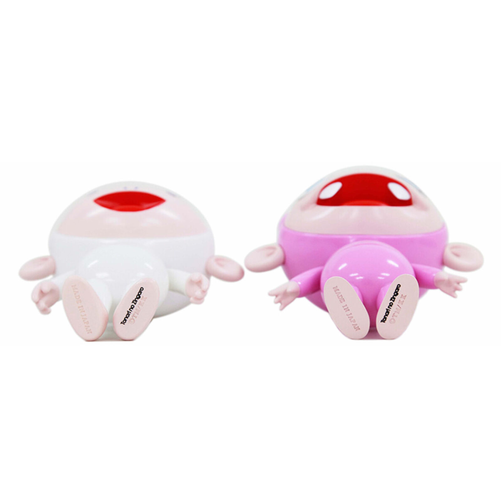 A couple of pink and white dolls standing next to each other.