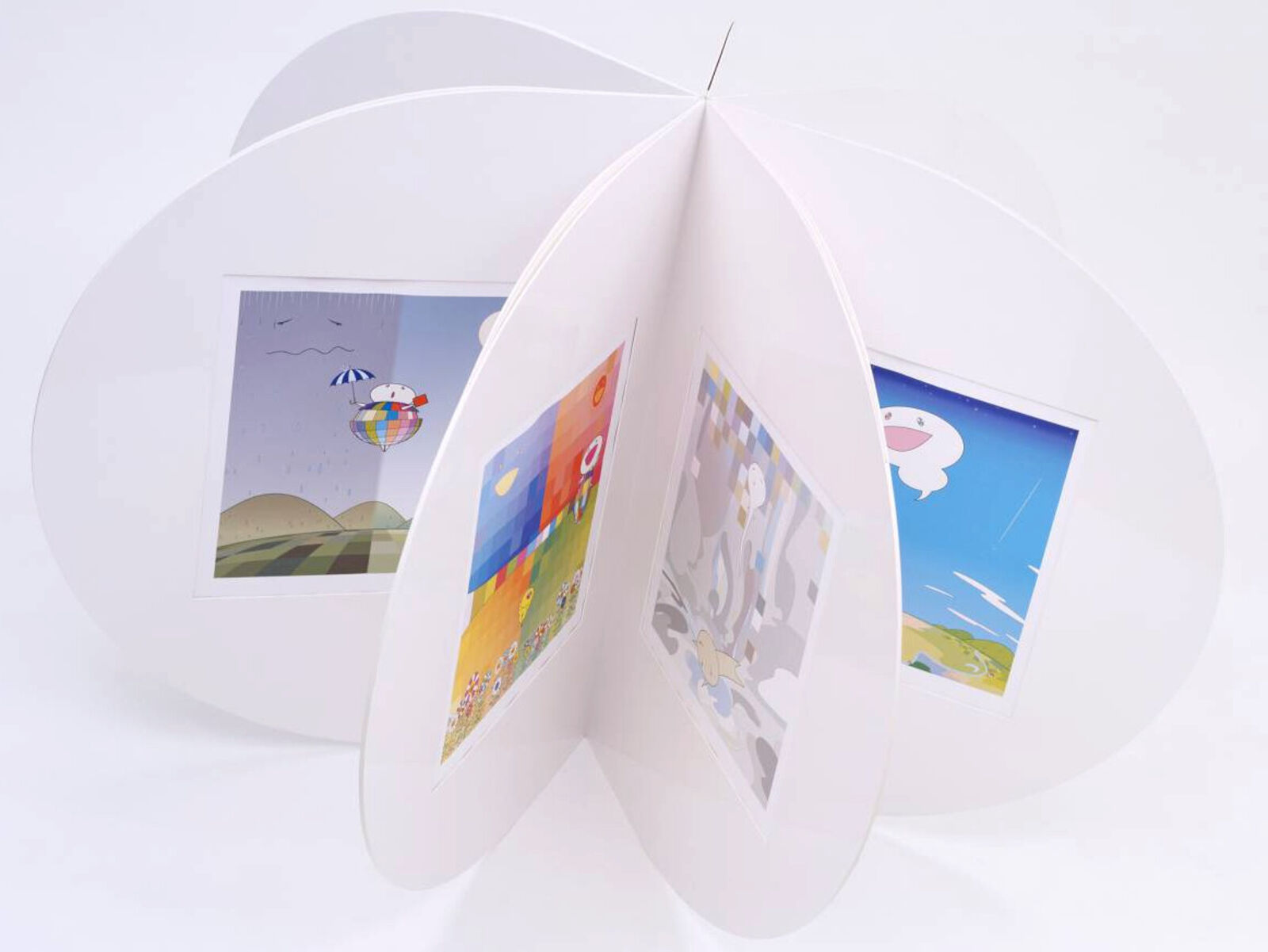 A white pop up book with three pictures inside of it.