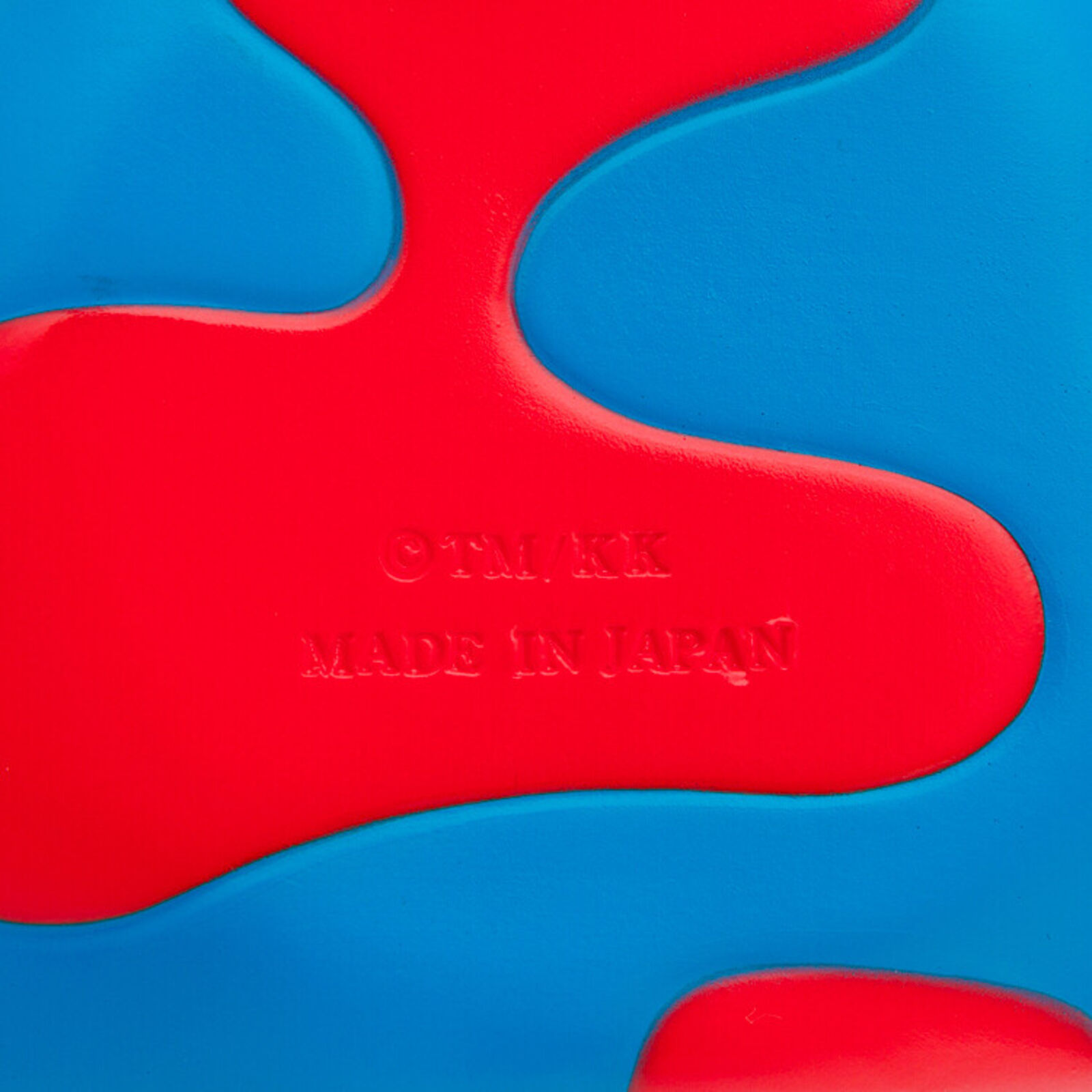 A red, white, and blue mickey mouse head with a big smile on it's face.